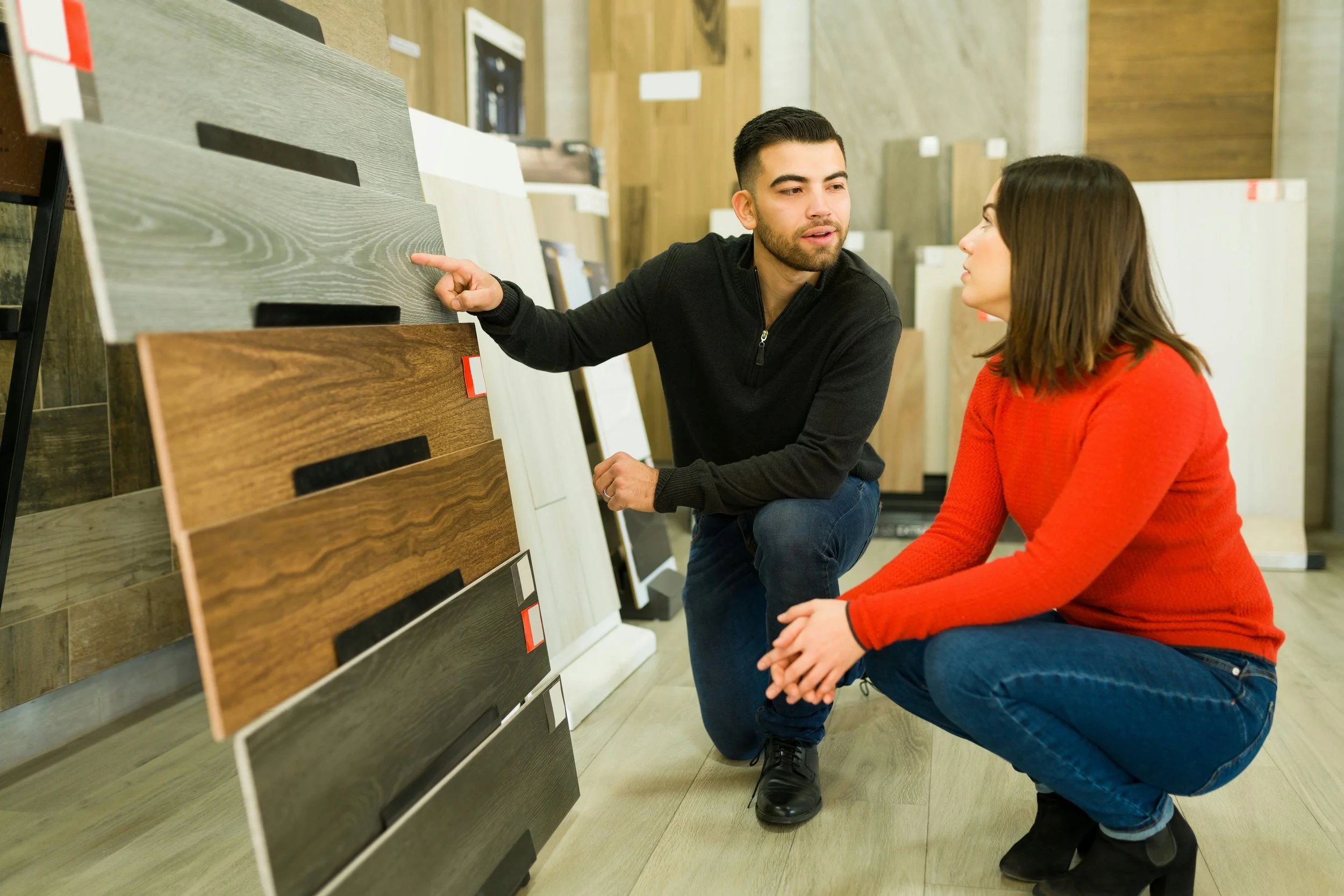 Staff talking to customer about tile flooring options