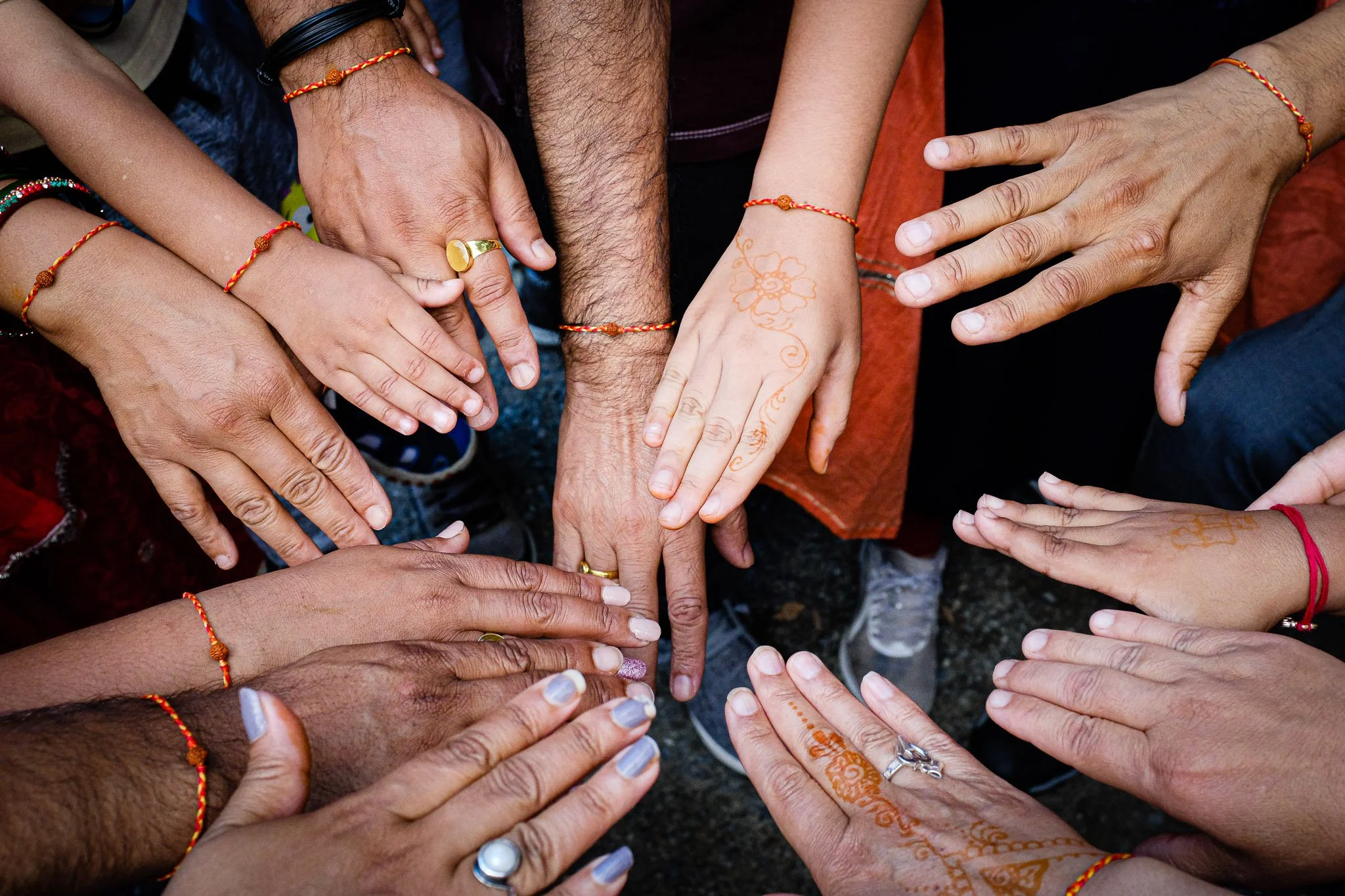 Hands in Rakhis and Henna.JPG