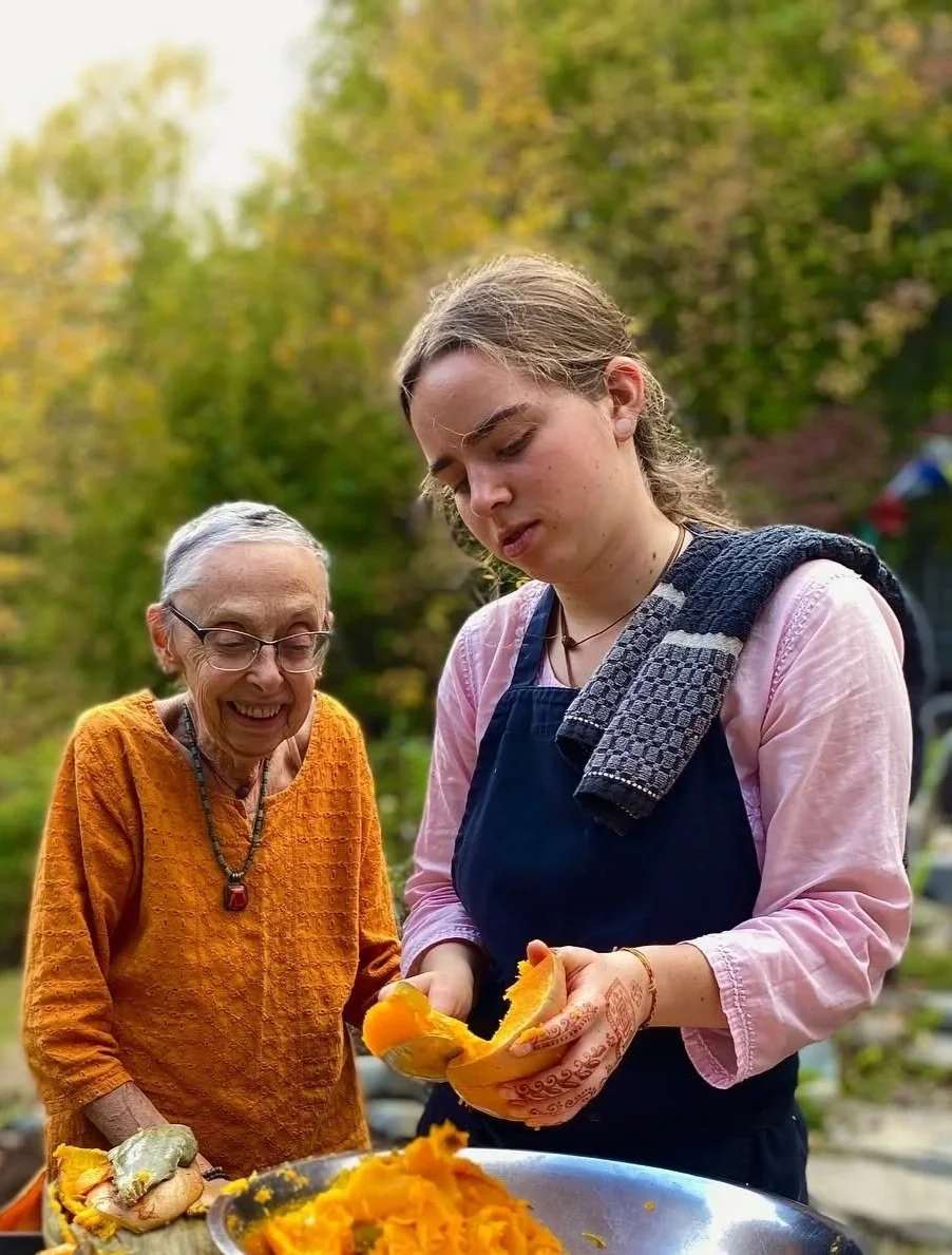 Kula and Kaya admiring fall Squash