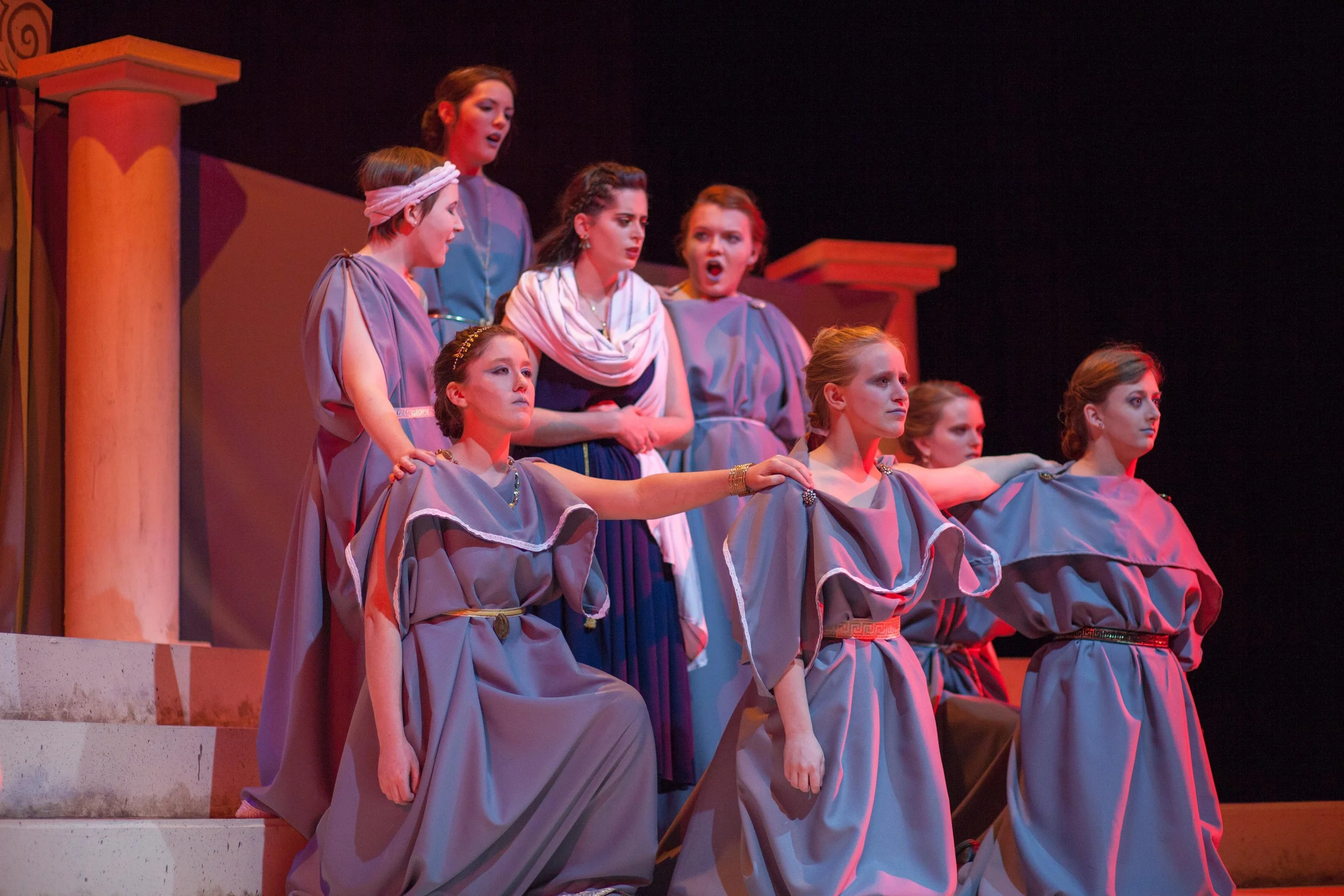 Production photo from SBU Theatre's production of Medea. Pictured: Medea center stage, surrounded by the Greek chorus of women.