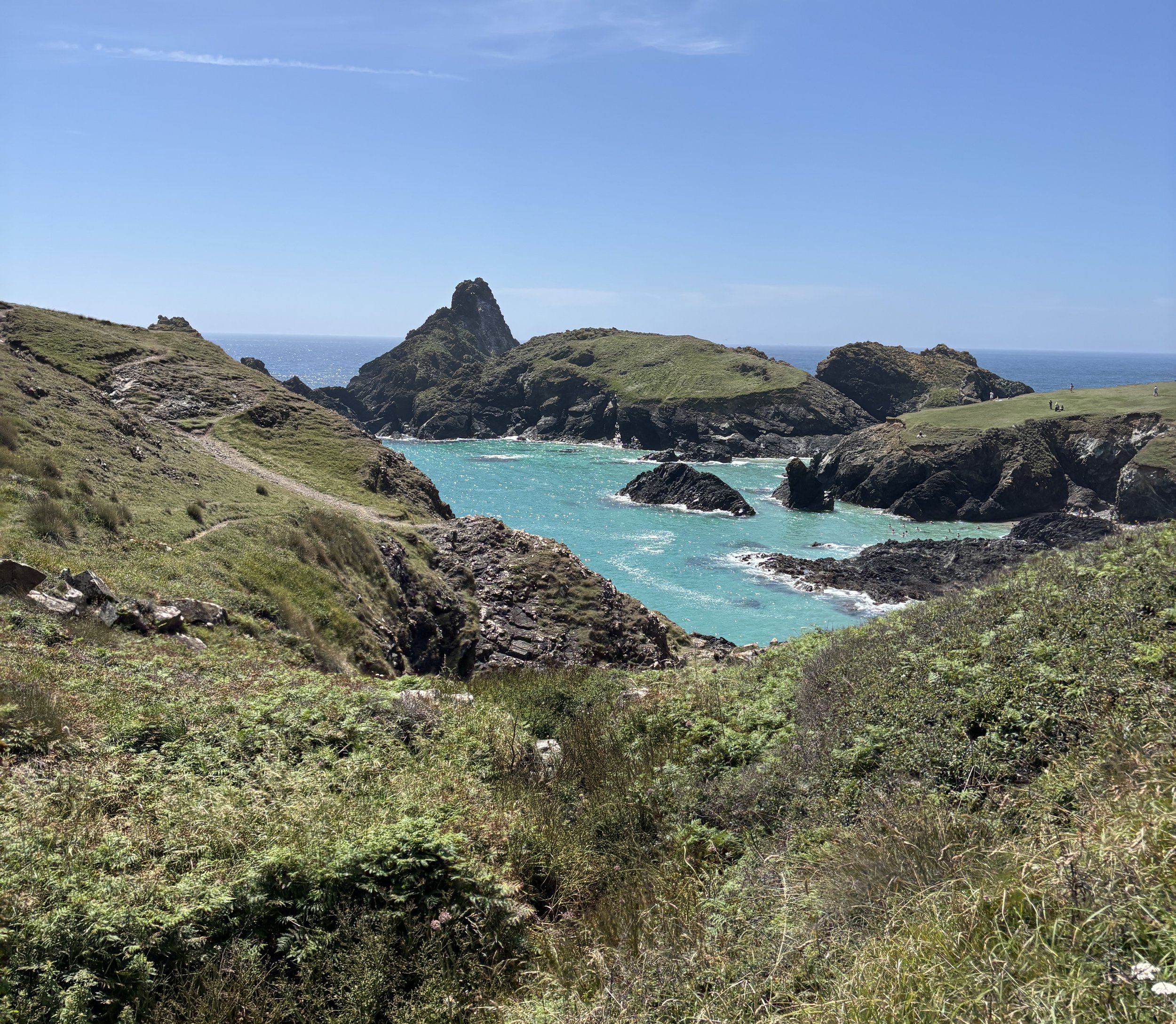Azure blue waters and dramatic coastline of Kynance Cove in Cornwall