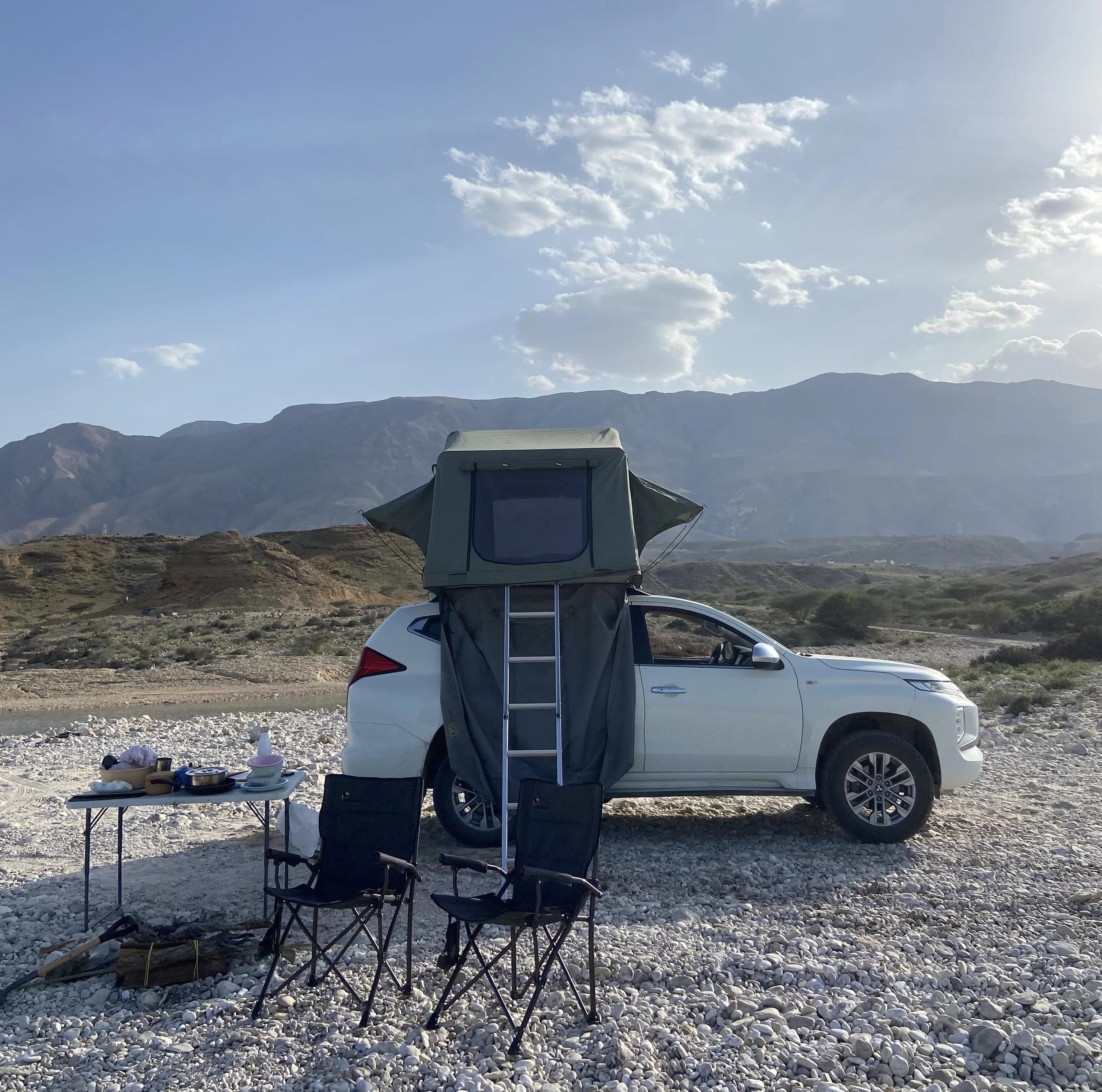 A 4x4 with a roof tent wild camping Camping alongside Wadis in Oman