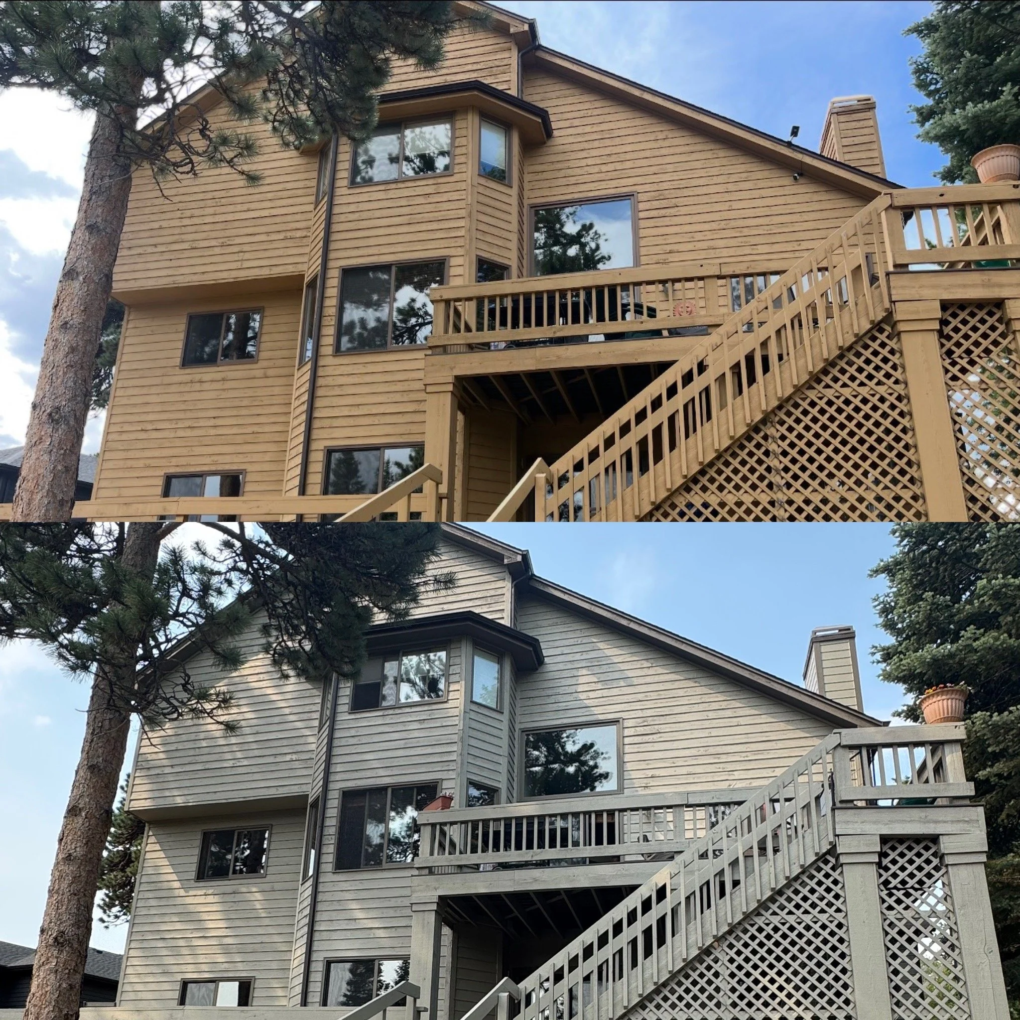 A multi-story wooden house with large windows and a balcony, surrounded by tall pine trees under a partly cloudy sky.