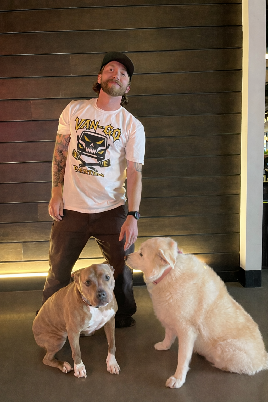 Dylan Alito, owner of Van-Go Painting, with his two dogs