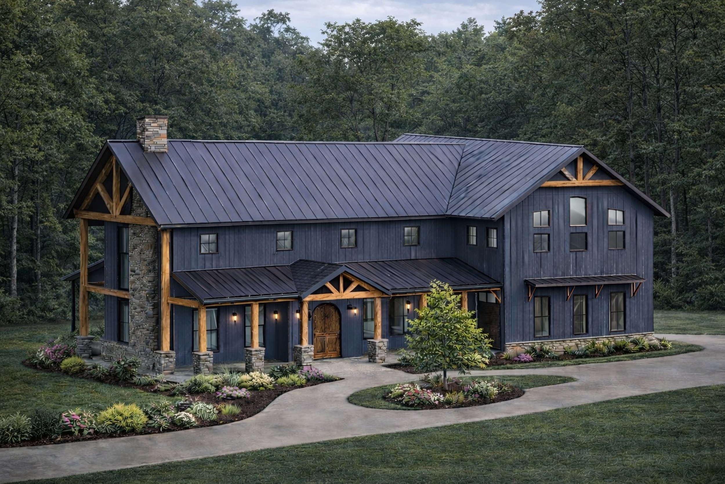 A large house with a dark blue exterior and a metal roof, surrounded by a landscaped yard with a curved walkway, grass, and flowerbeds, with a dense forest in the background.