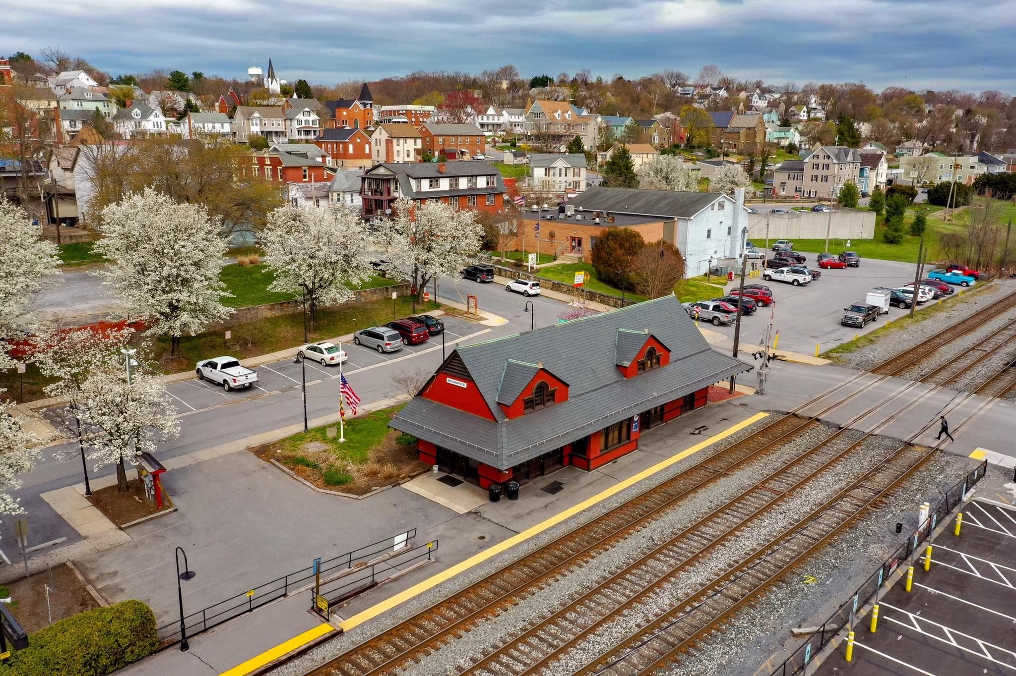 Arial view of a trains station, railroads, cars, and homes in Brunswick, Maryland