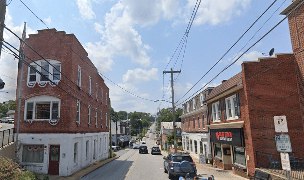 Picture of downtown Mount Air, Maryland with rowhomes, shops, and cars