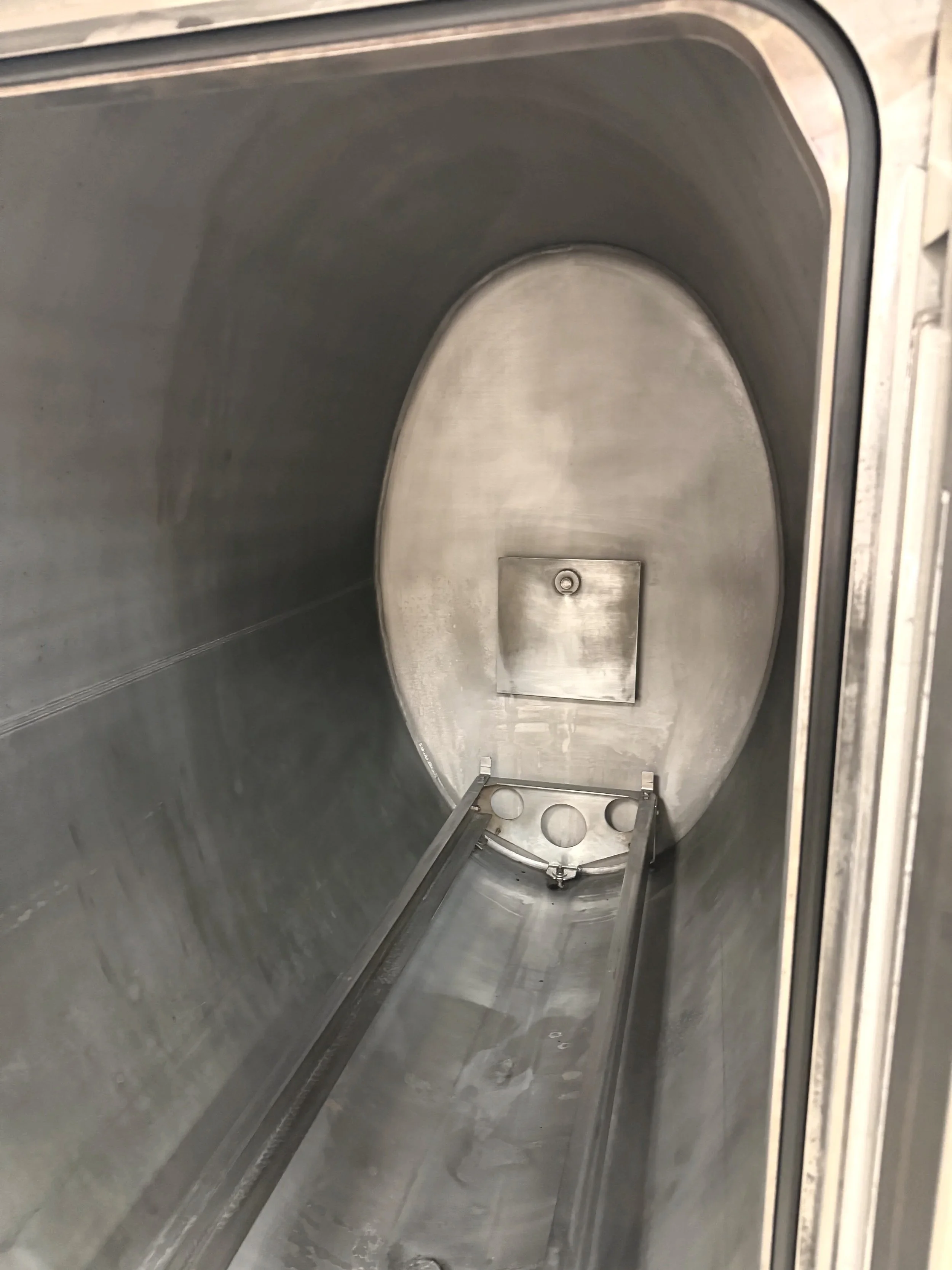 Empty, stainless steel, autoclave to process surgical instruments and equipment.