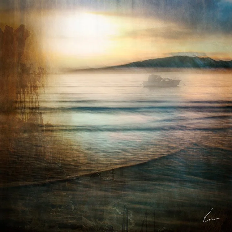 A blurry, artistic photograph of a sunset over water with a boat in the distance and mountains on the horizon.