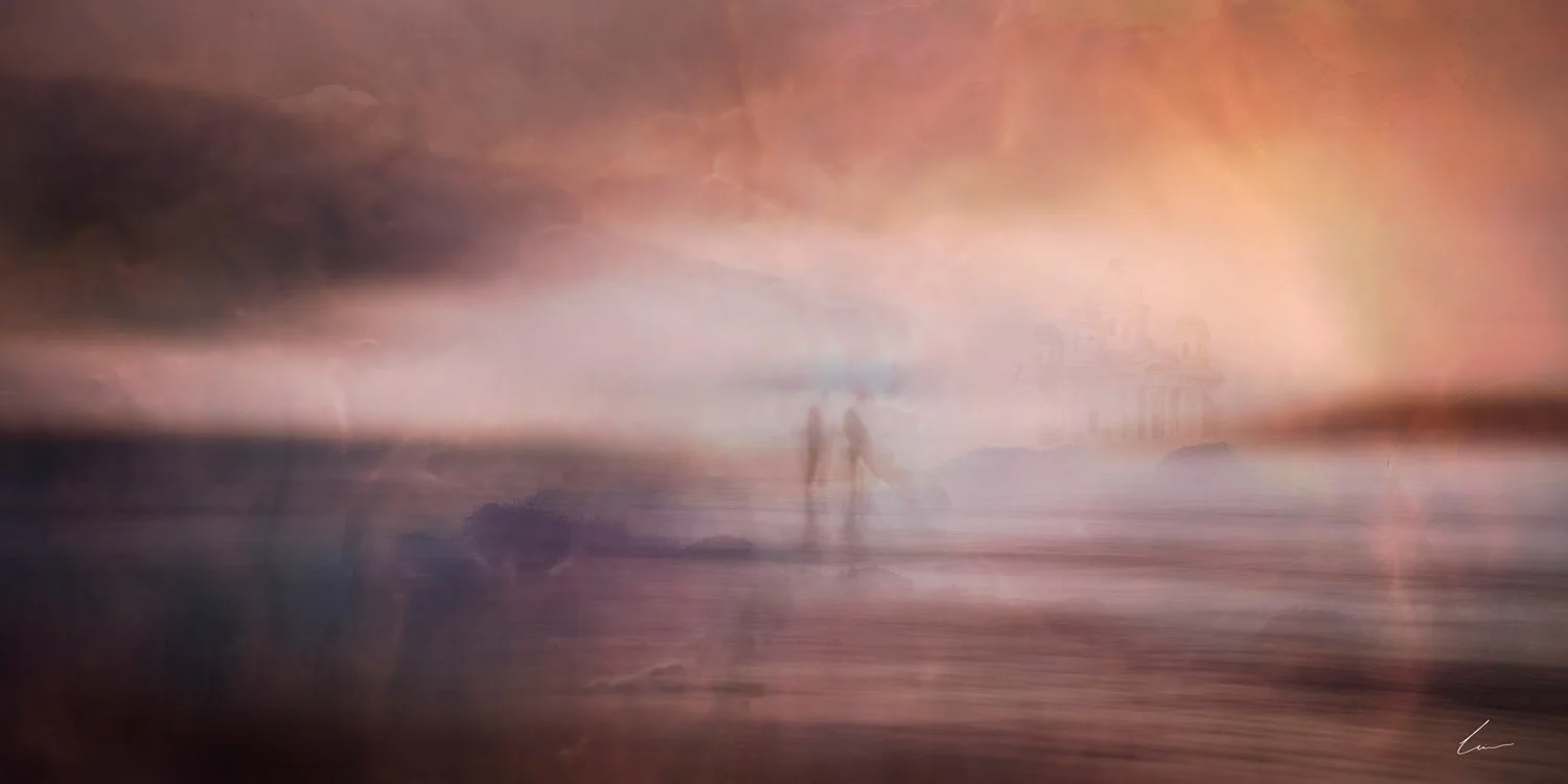 A blurry beach scene at sunset with two people walking along the shoreline, and clouds in the sky.