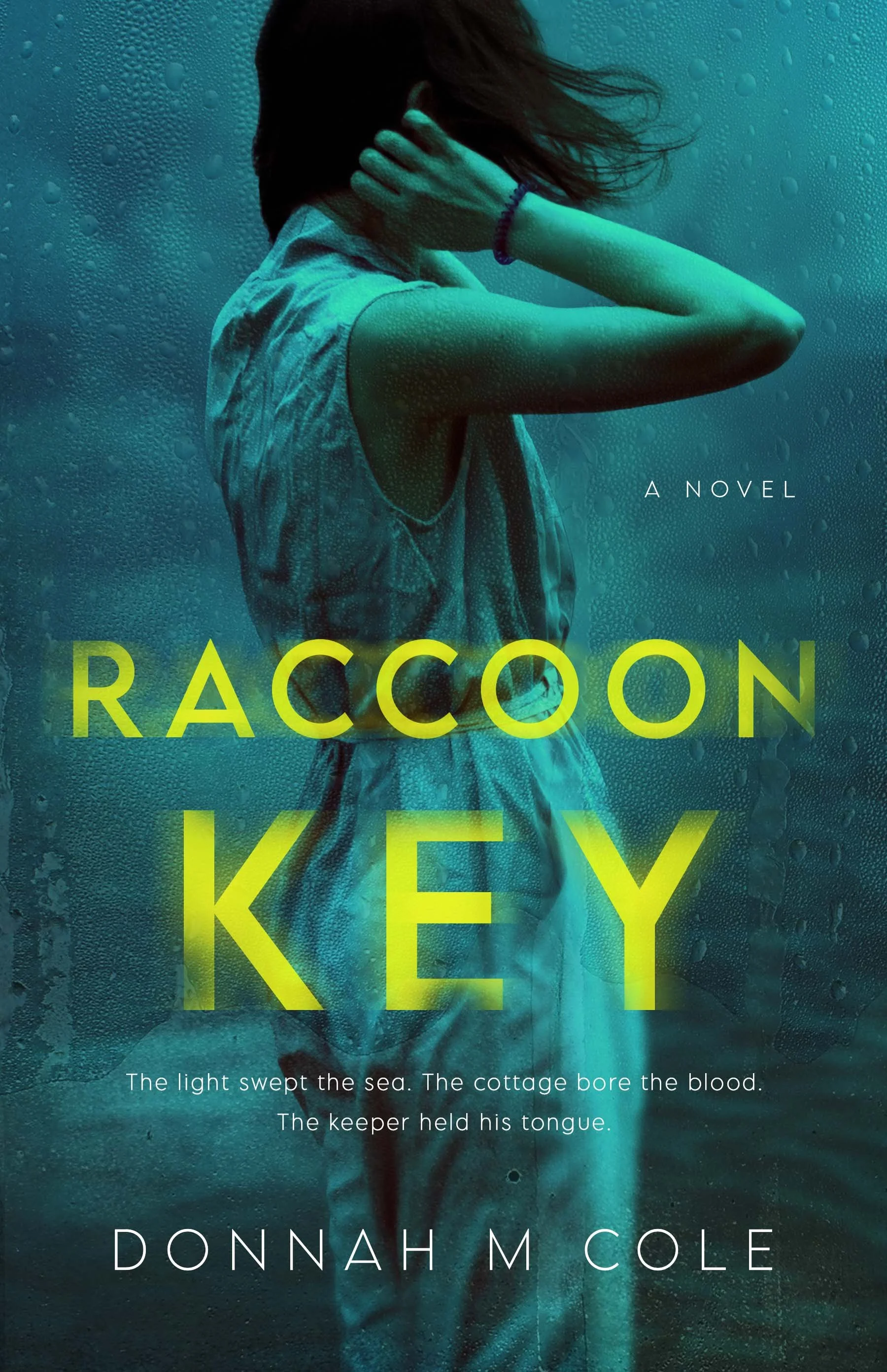 Book cover for the novel "Raccoon Key" by Donnah M. Cole, featuring a woman with dark hair, wearing a sleeveless shirt, holding her neck with both hands, standing behind a rain-covered glass surface.