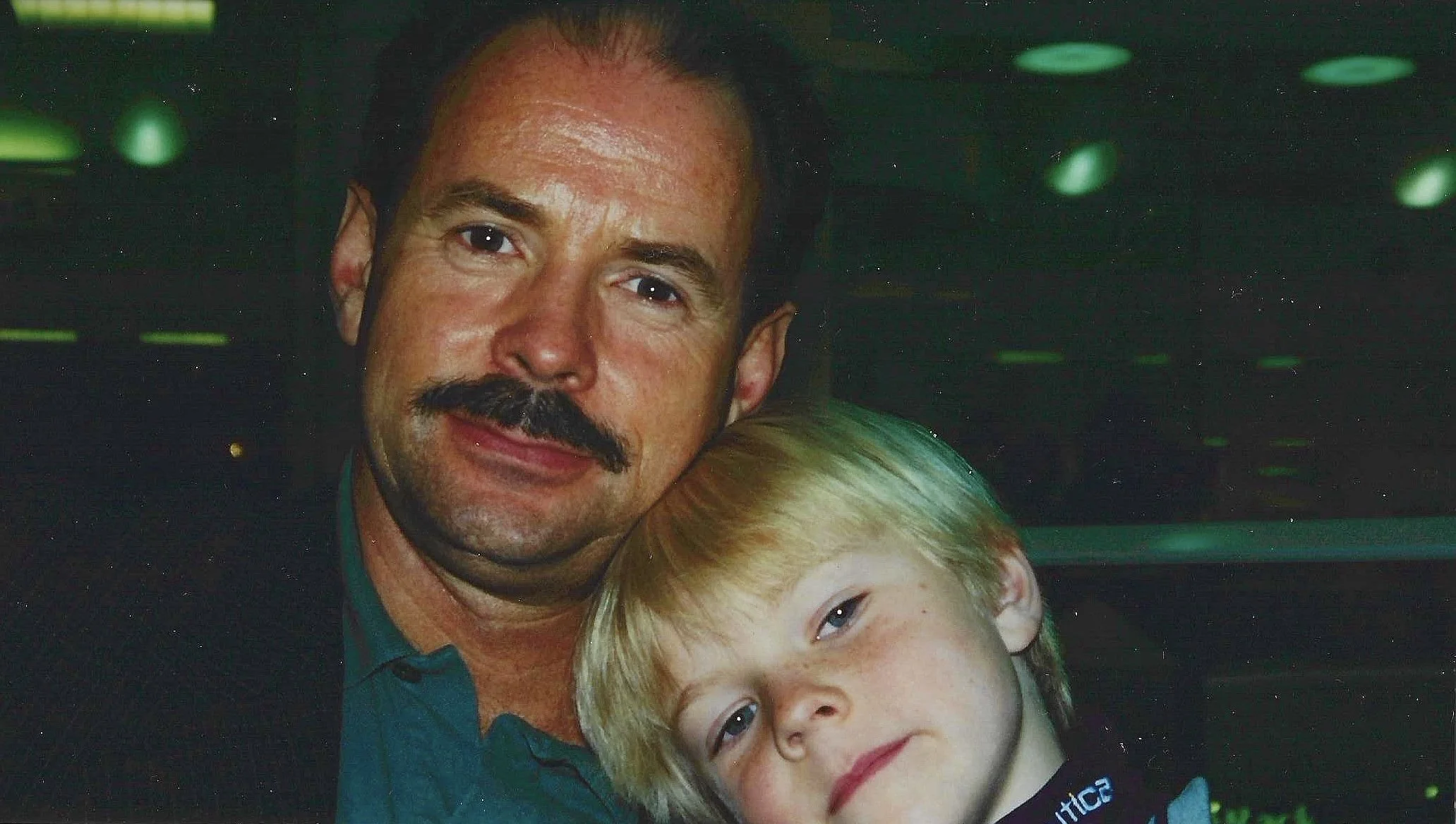 David Wilkie with his son Adam Wilkie posing together indoors.