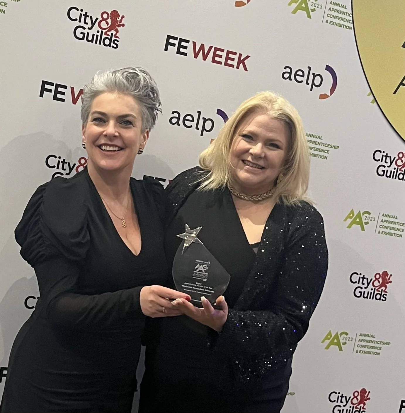 Coral Grainger with the team's award at the AAC 2023 Apprenticeship Awards
