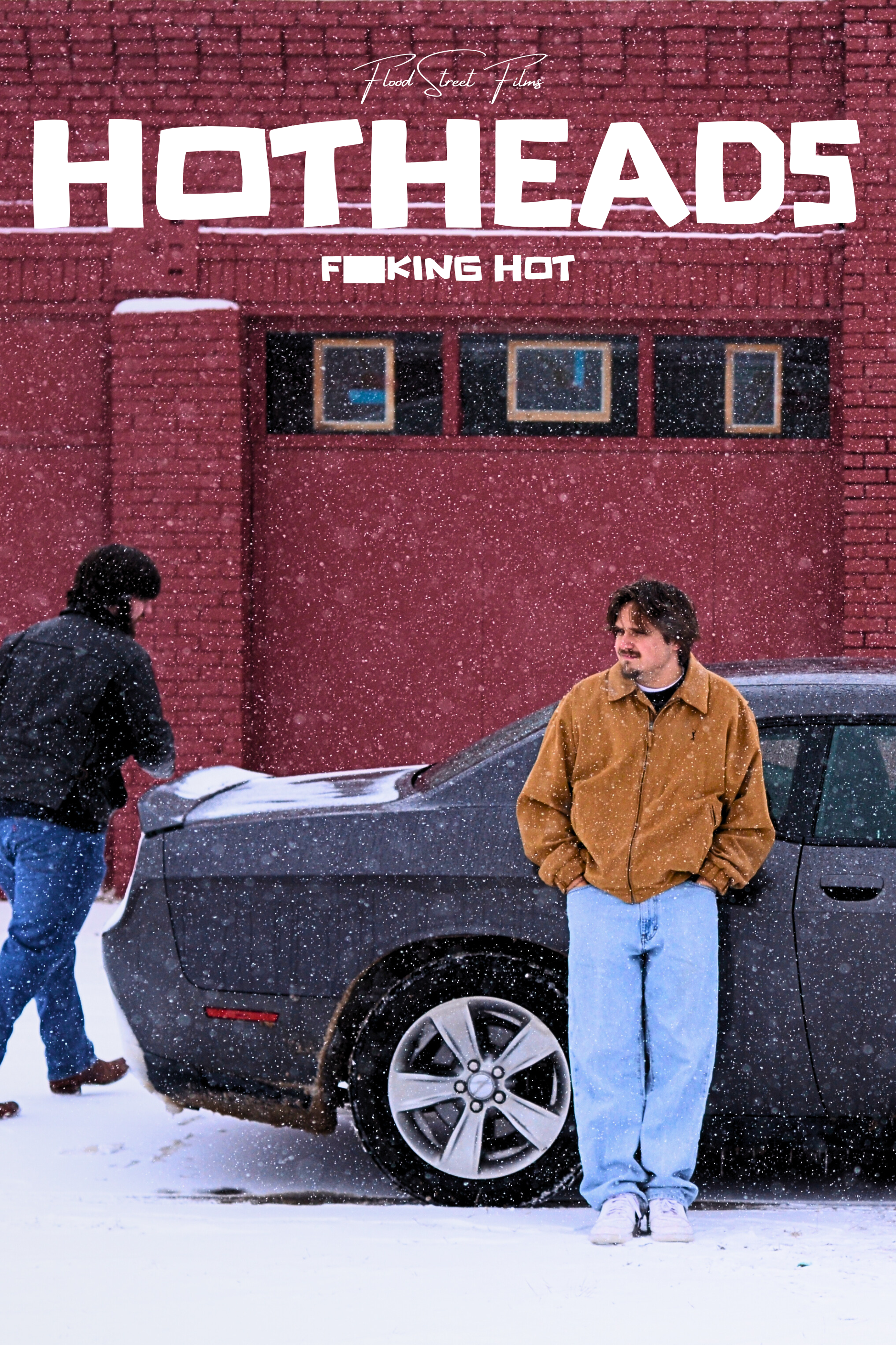 Ryan Christopher Park & Jake Ayers in the poster for the short film, HOTHEADS (2025). A red brick building with small windows is in the background. The text on the image reads 'Food Street Films,' 'HOTHEADS,' and 'F***ING HOT.'
