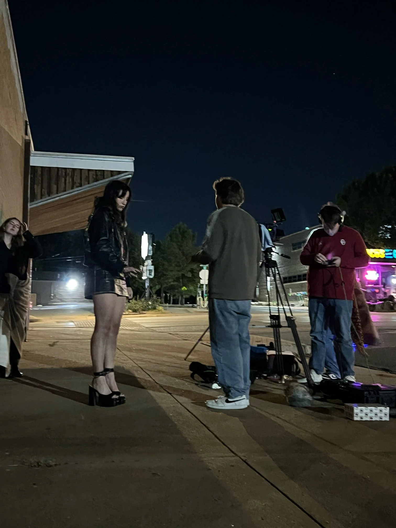 Behind the scenes photo from 'Call Girl' (2025) with the crew filming Conner Cagle on a sidewalk outside, with Ryan Christopher Park giving direction.