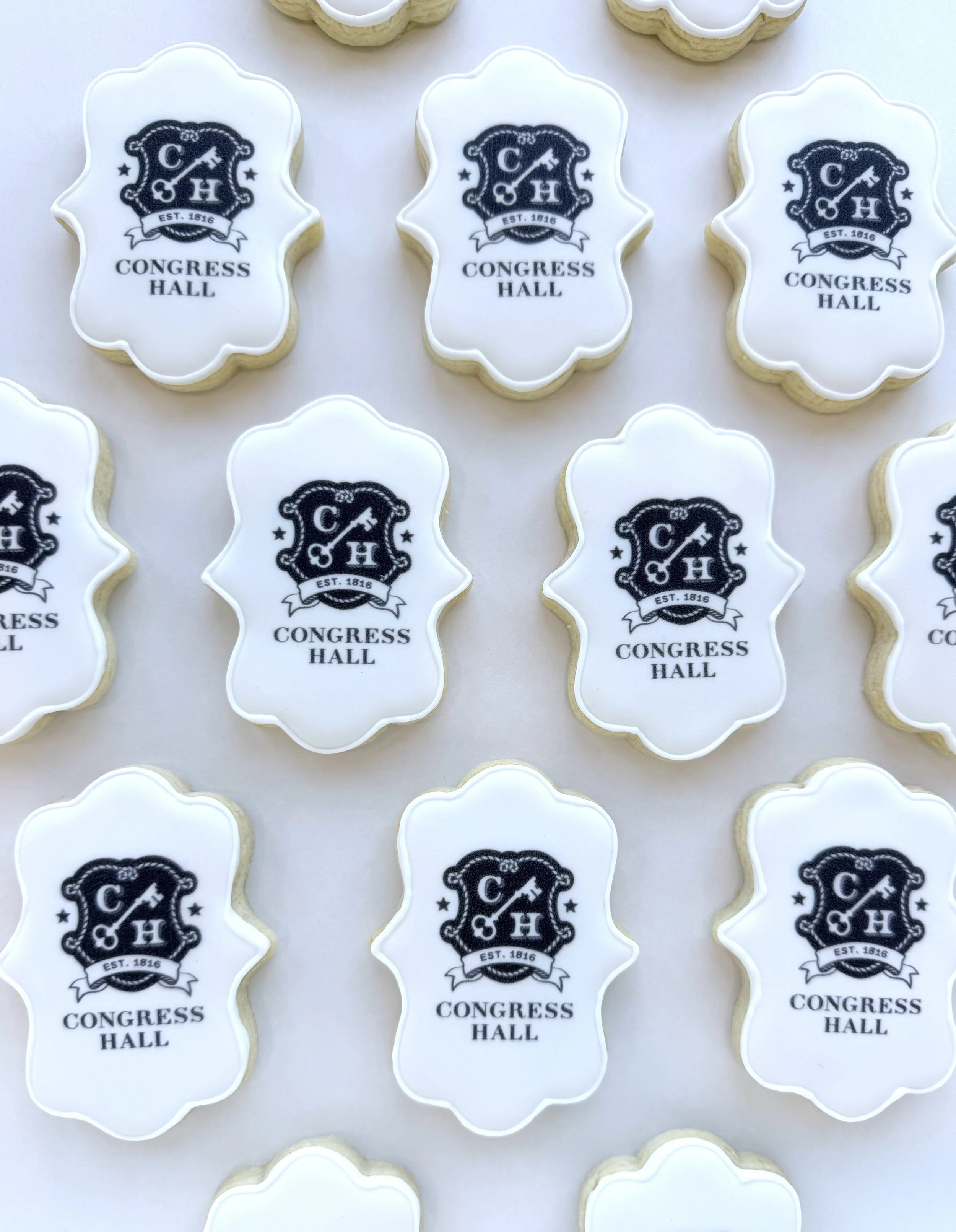 Cookies decorated with a Congress Hall logo featuring a shield with a key, the text "EST. 1816," and the words "CONGRESS HALL" underneath.