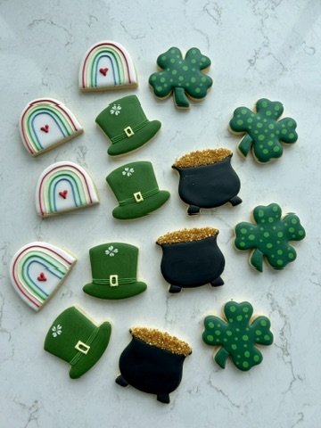 St. Patrick's Day themed cookies including rainbows, shamrocks, leprechaun hats, and pots of gold