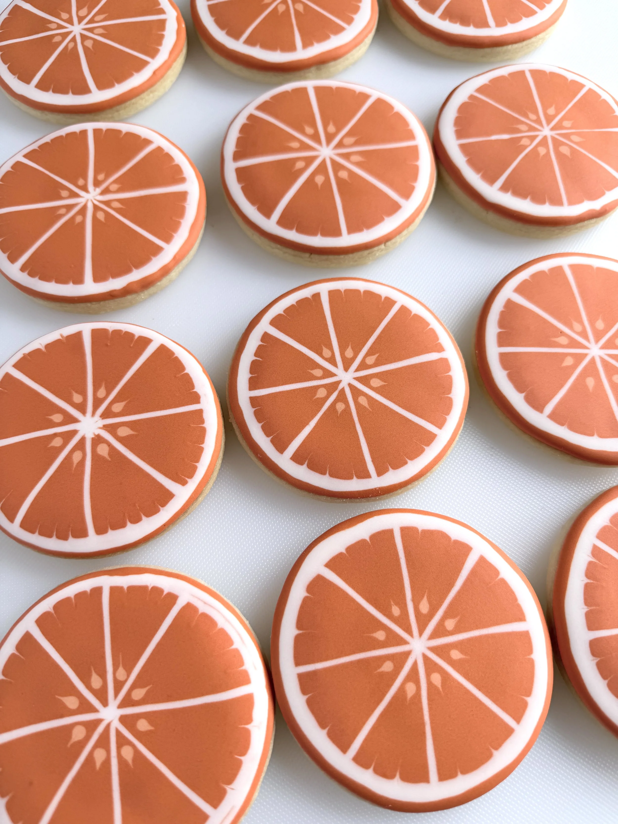 Cookies decorated with icing to look like orange slices.