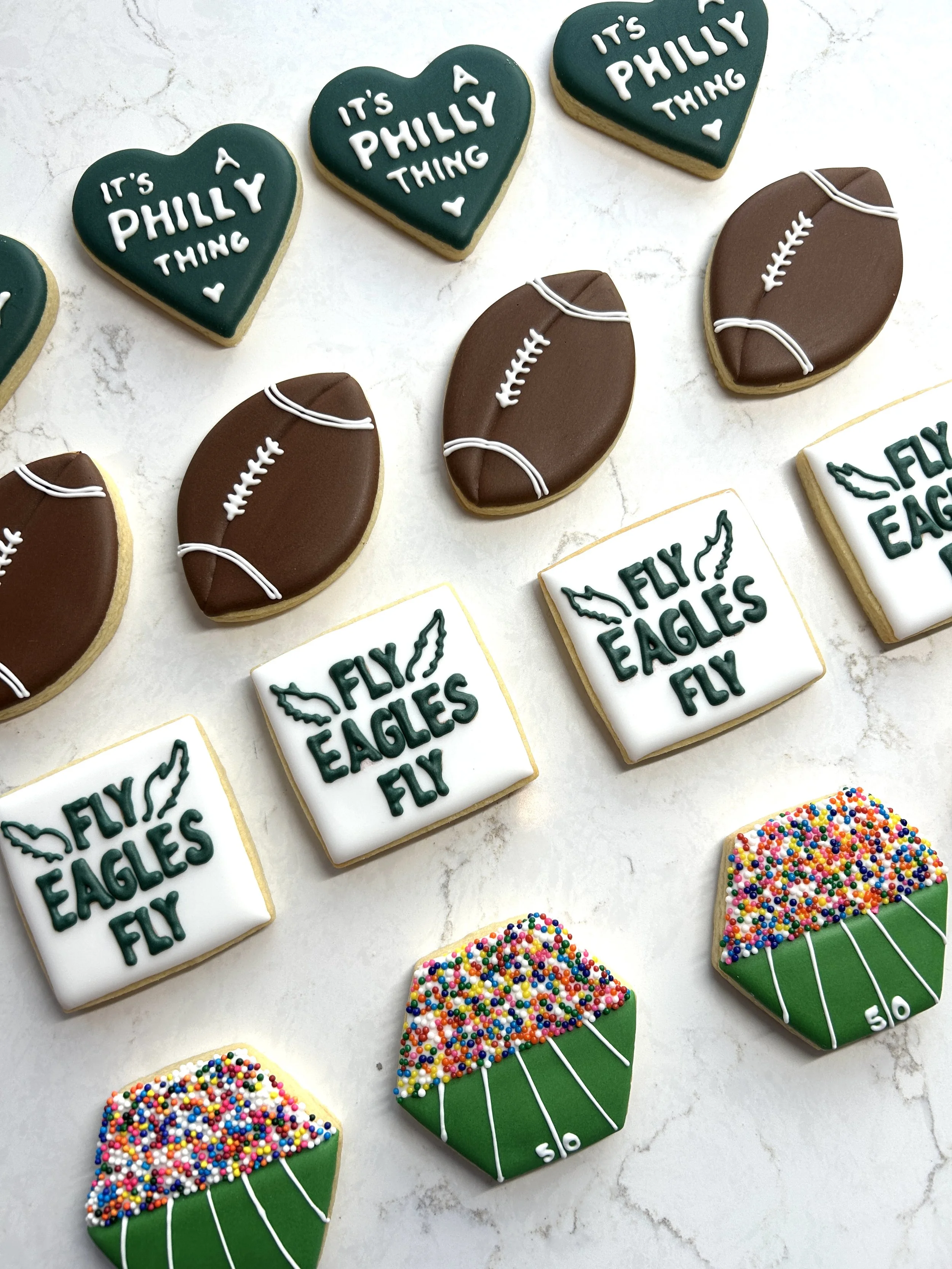Decorated cookies with football themes and phrases like 'It's a Philly Thing.'