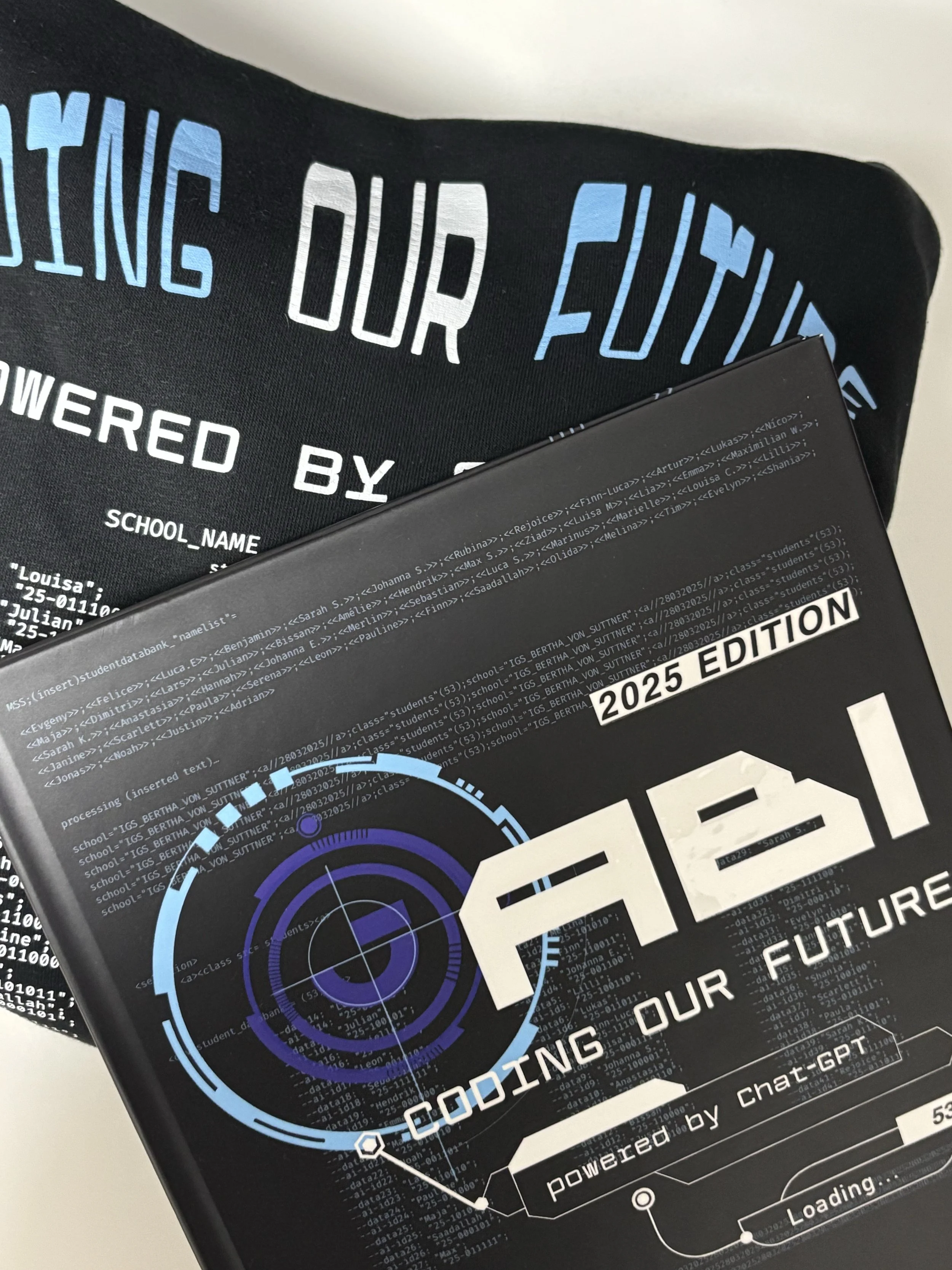 Graduation Yearbook and Hoodie designed by my friend and me for our graduation in 2025 with the prompt A(B)I: Coding our Future