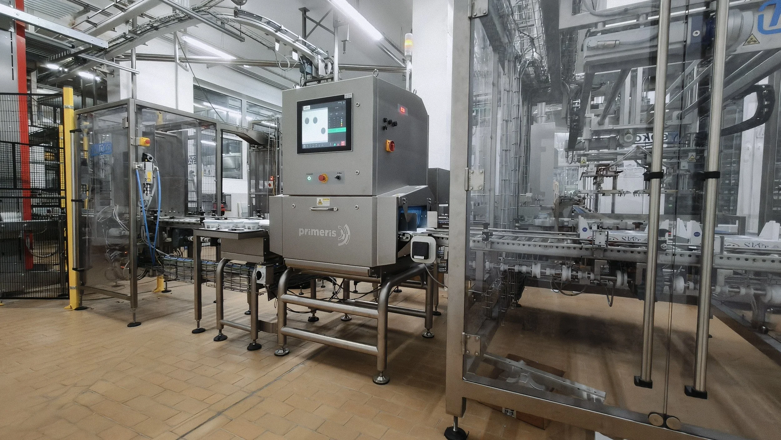 Industrial manufacturing equipment with automated machinery and conveyor system in a factory setting.