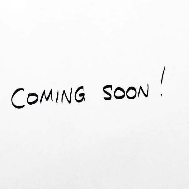 Handwritten message on paper that says 'Coming Soon!'