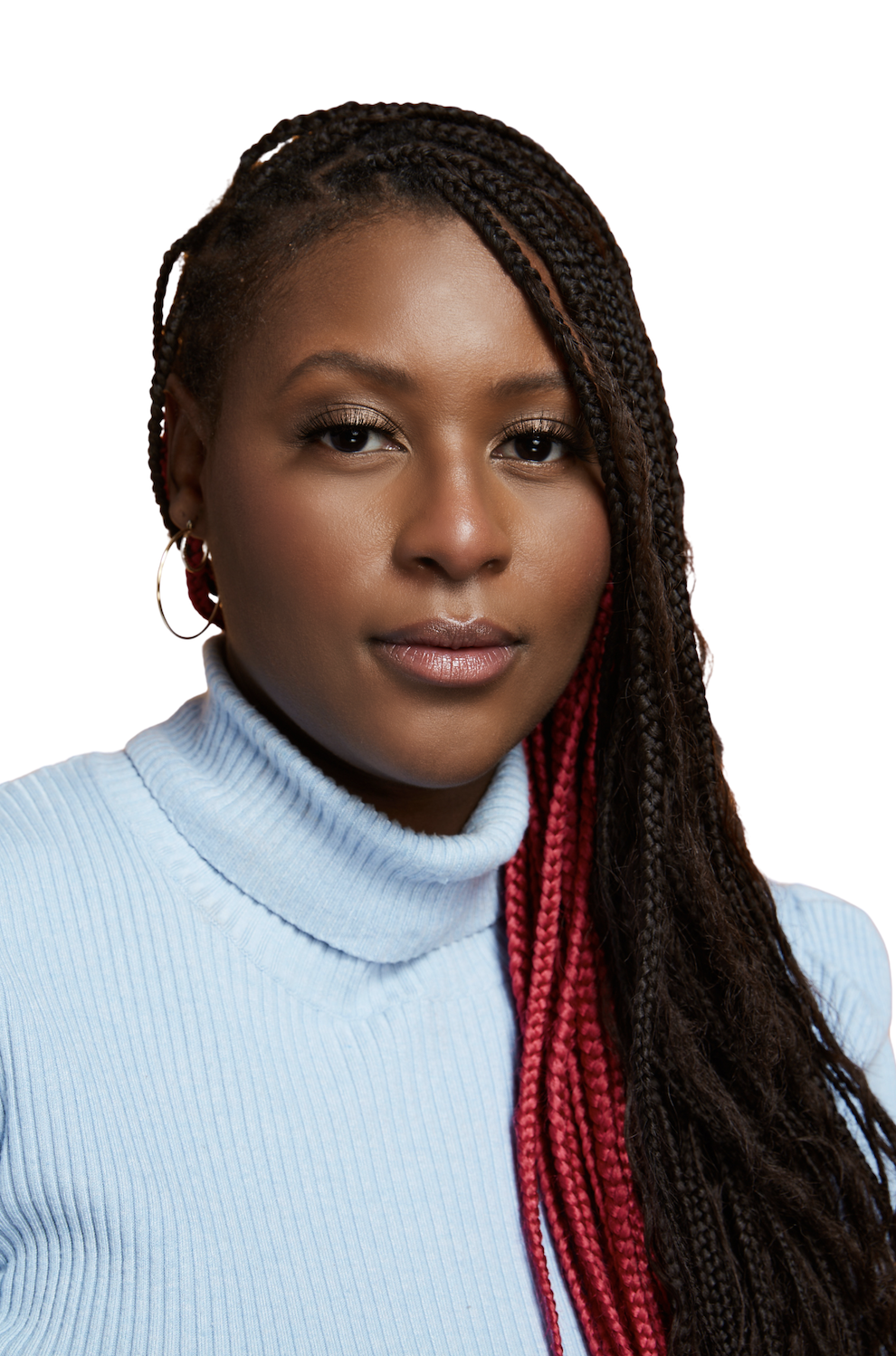 A portrait of a Black woman with long braided hair with red highlights, wearing a light blue turtleneck sweater, and hoop earrings, against a white background.