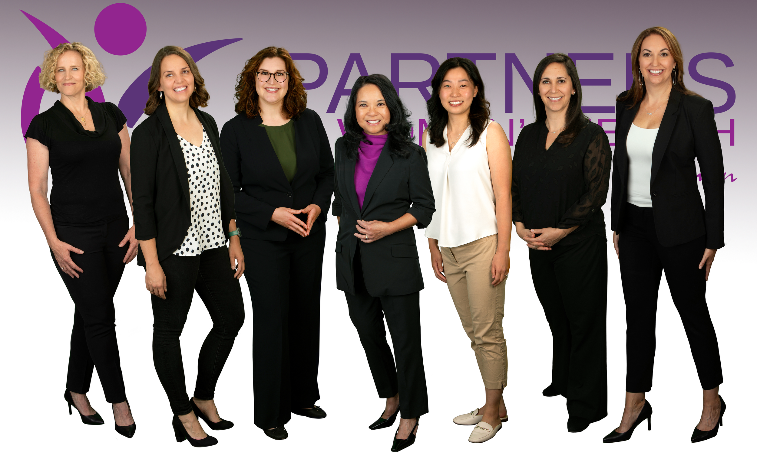 Group of seven women’s health providers at Partners in Women’s Health, a women-owned medical practice in Denver, smiling together with logo in background