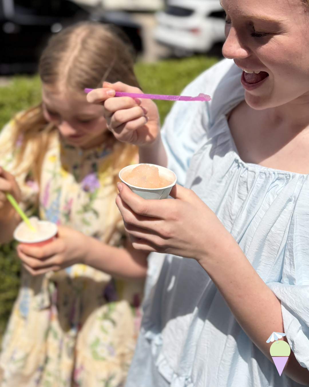 two young girls, eating dye free snowcones