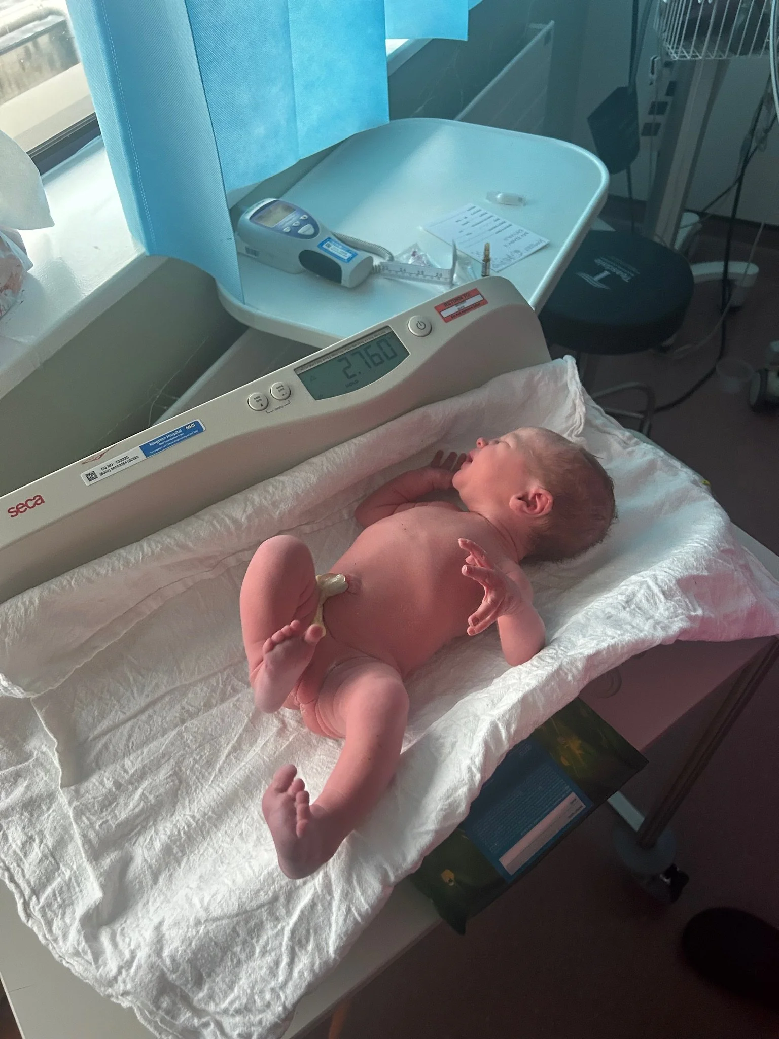 A newborn baby being weighed shortly after birth. Shared with permission.