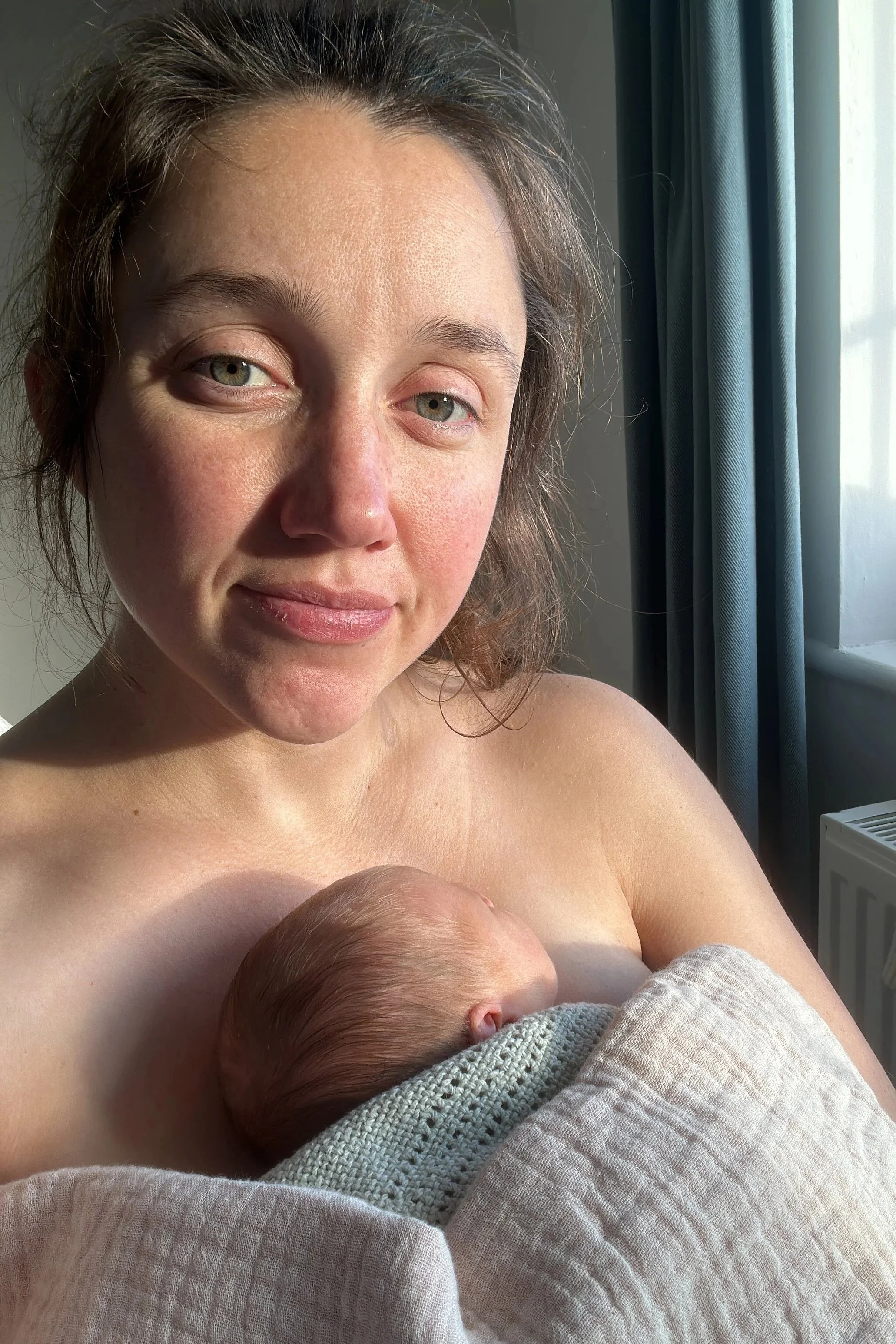 Alice holding her daughter to her chest, skin-to-skin, two days postpartum.
