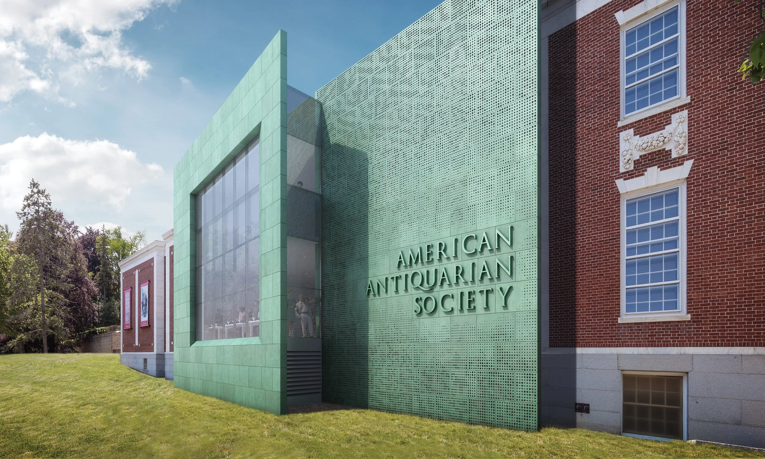 Exterior view of the American Antiques Society building with a green facade and large windows, adjacent to a red brick building with decorative white trim and multiple windows, surrounded by trees and a grassy lawn.