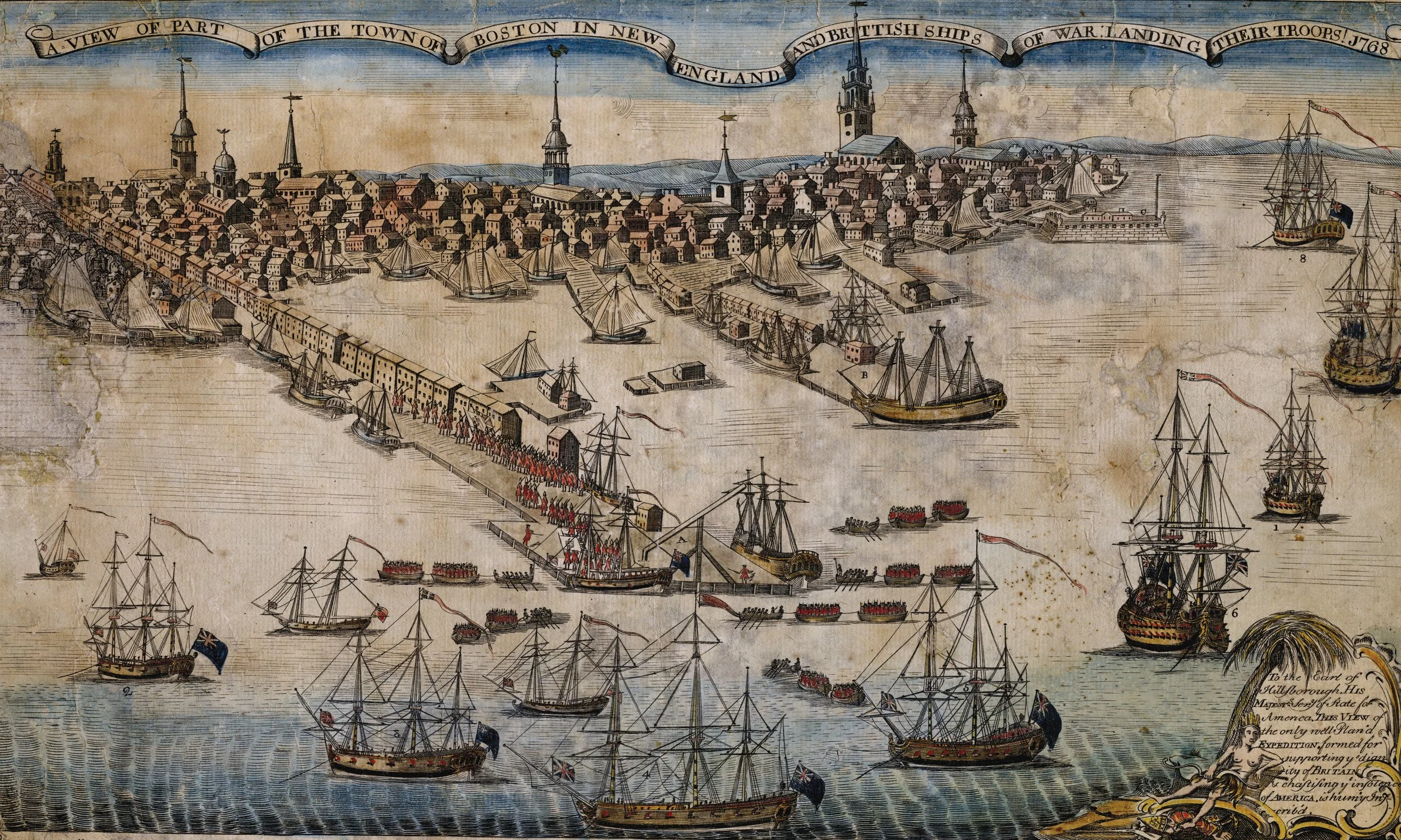 Historical map illustration showing part of Boston with numerous sailing ships in the harbor, colonial-style buildings, and church steeples. A banner at the top reads, 'A view of part of the town of Boston in New England and British ships of war landing their troops 1768.'