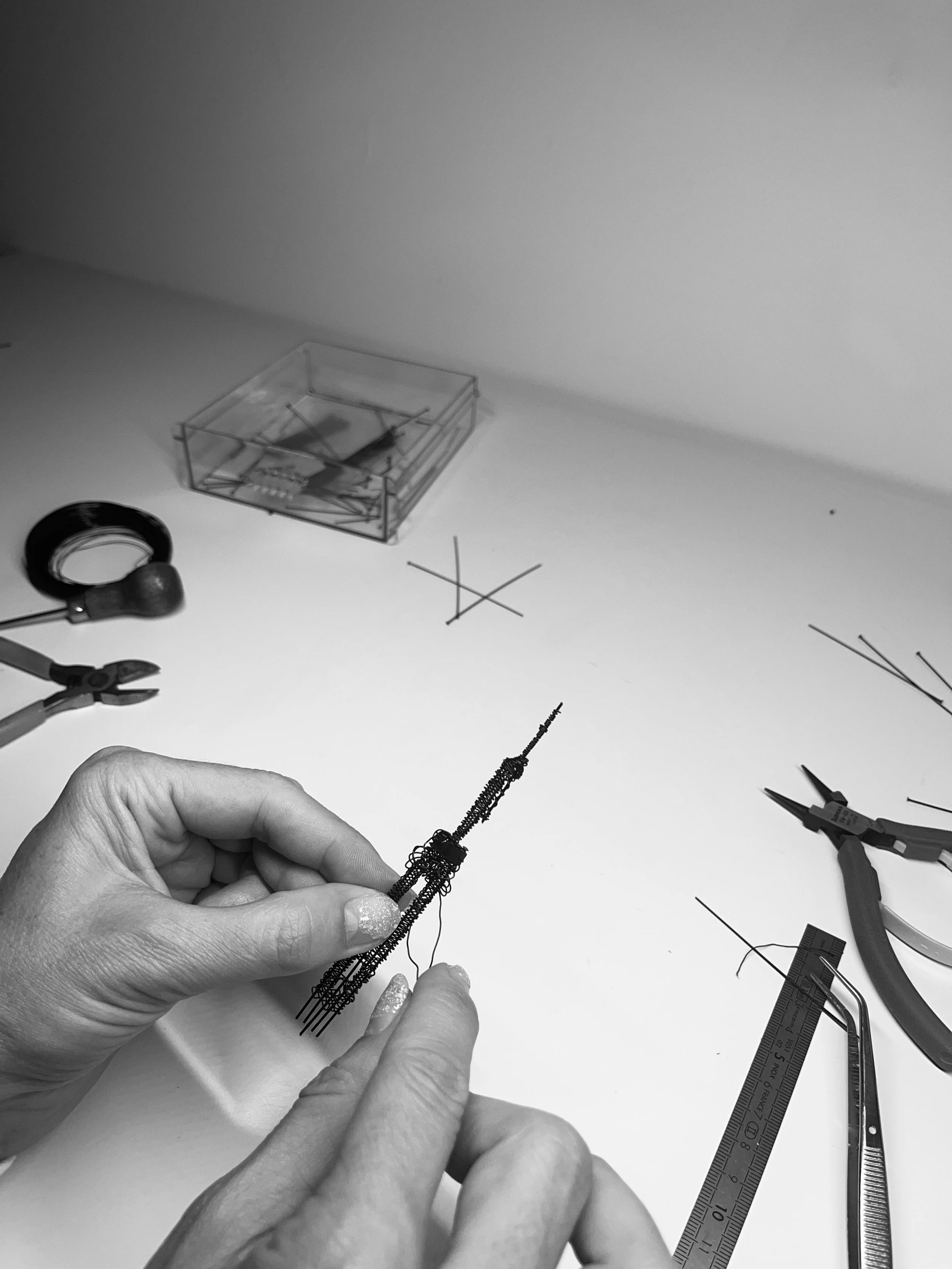 Close-up of Sarah Esmoingt’s hands crafting the spire detail for the Empeiria garment