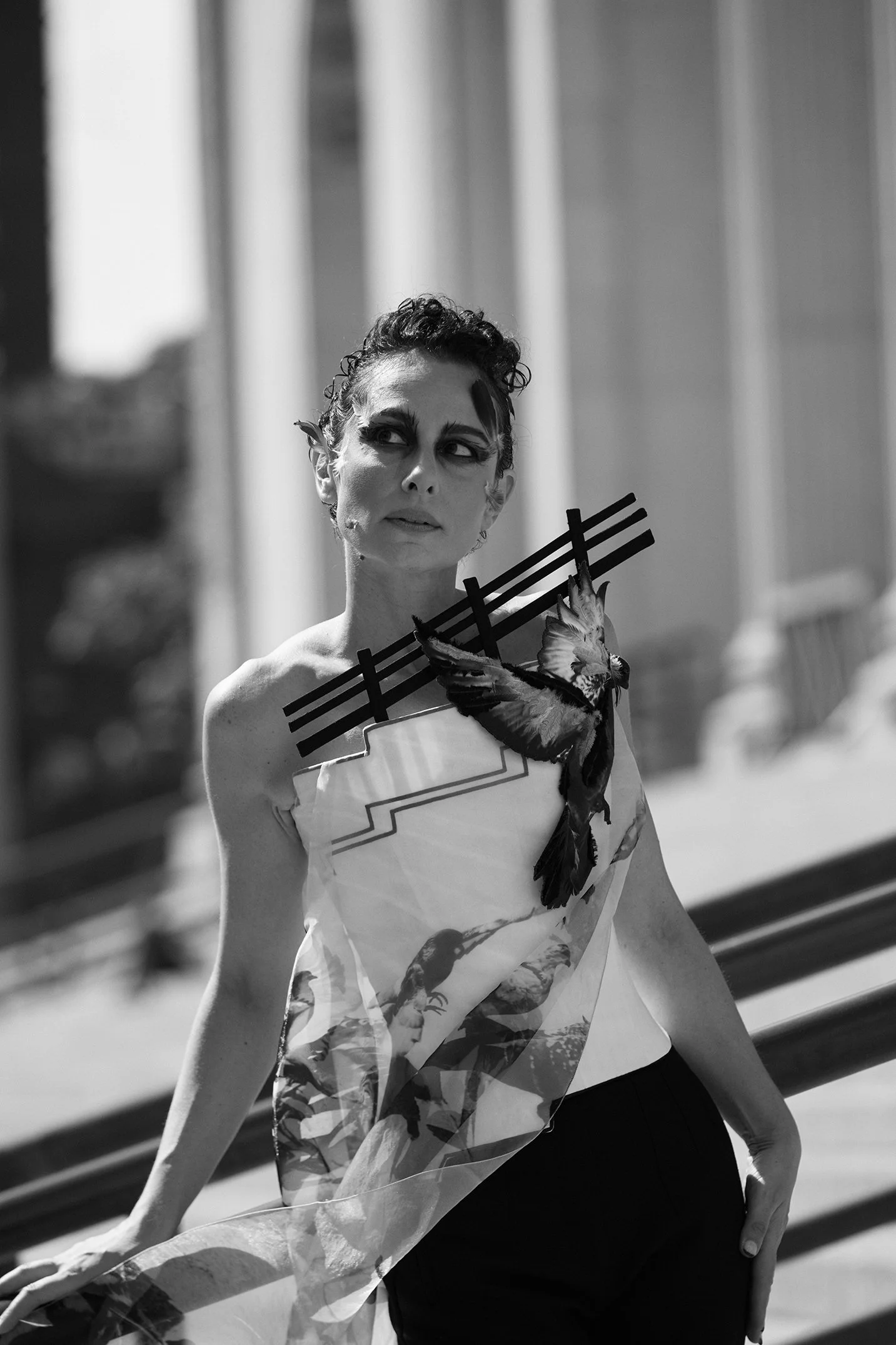 Nicky Conti wearing the Adaptress couture look inspired by pigeons, photographed on the James Farley Building stairs in New York City