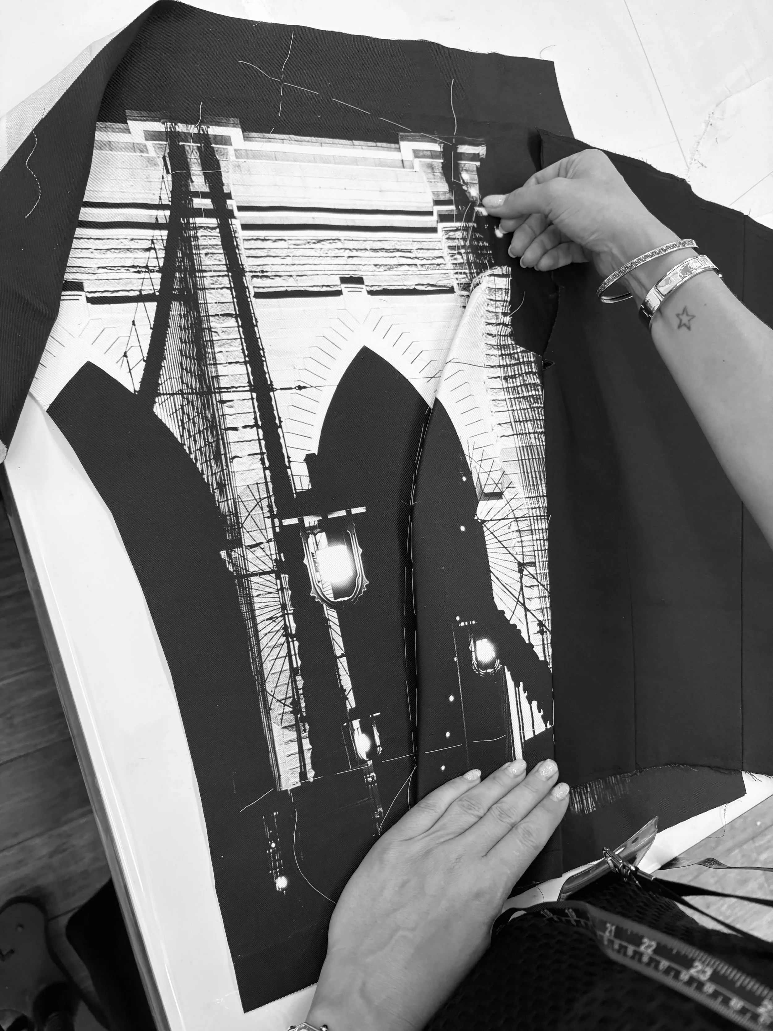 Estelle Chatorrier stitching parts of the custom couture jacket part of the Robe-ling outfit