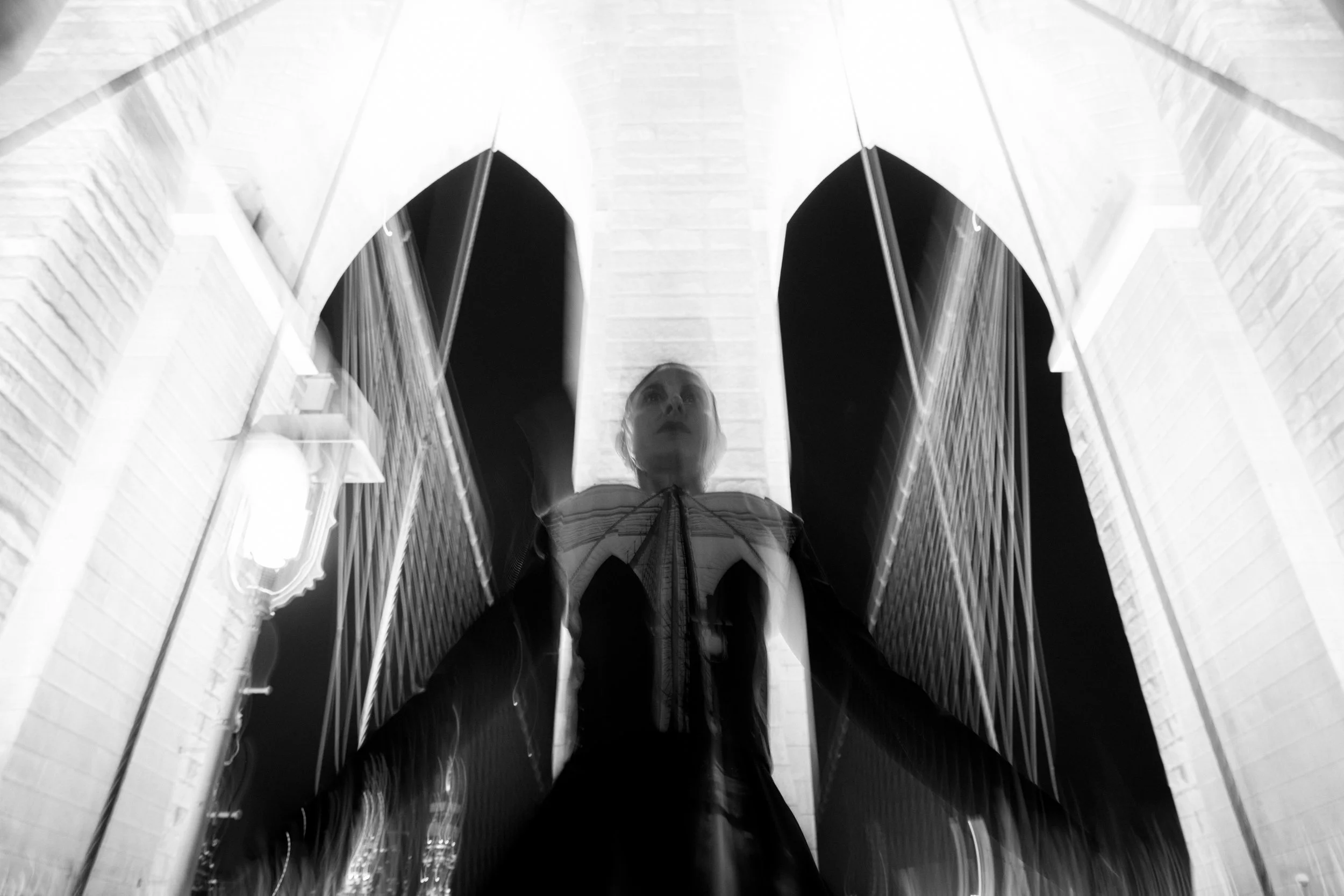 Silhouette of Nicky Conti wearing the look echoing the arches of the Brooklyn Bridge