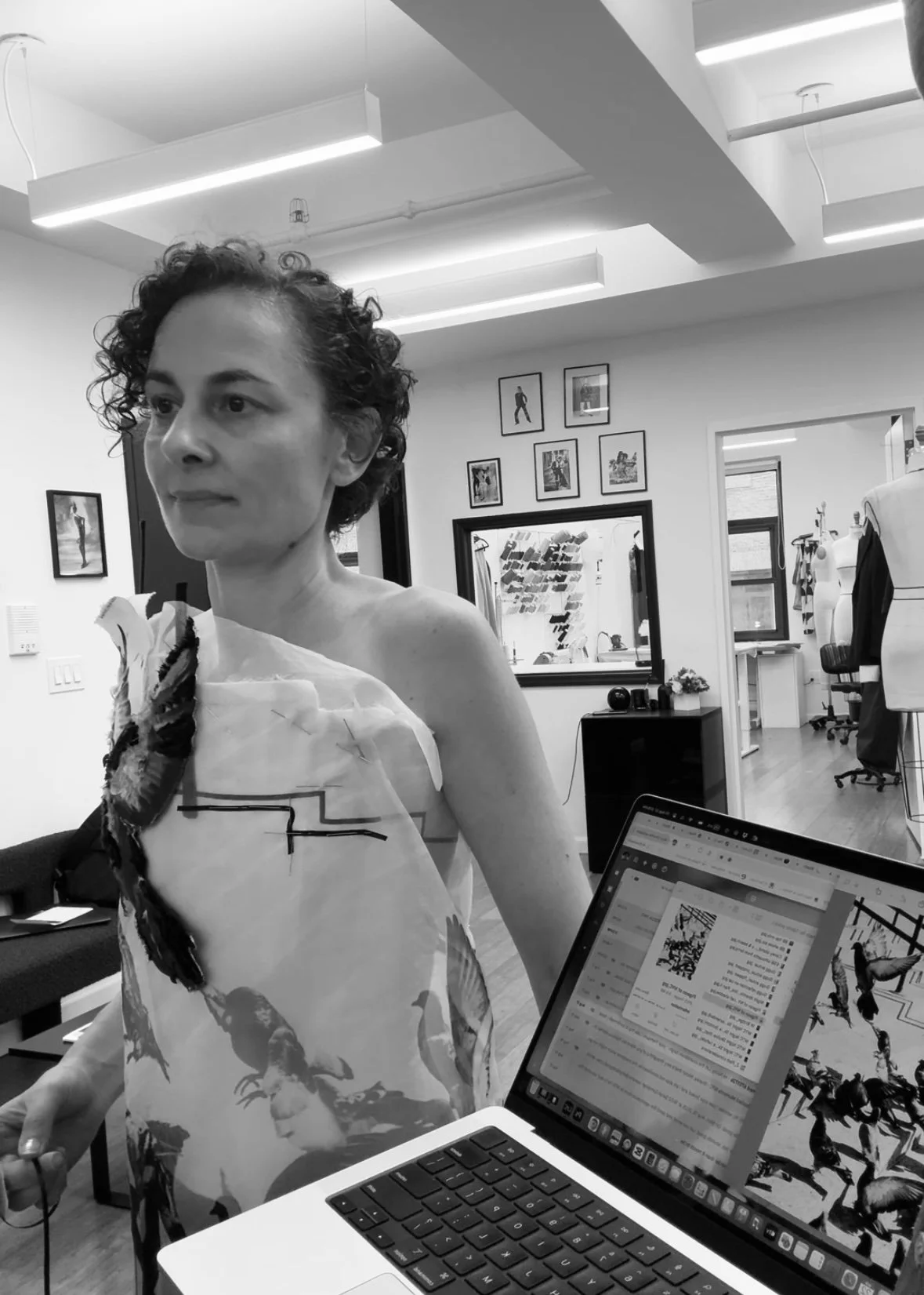 Nicky Conti at a fitting in Estelle Chatorrier’s atelier, with a laptop open displaying the original pigeon photograph used for the Adaptress design