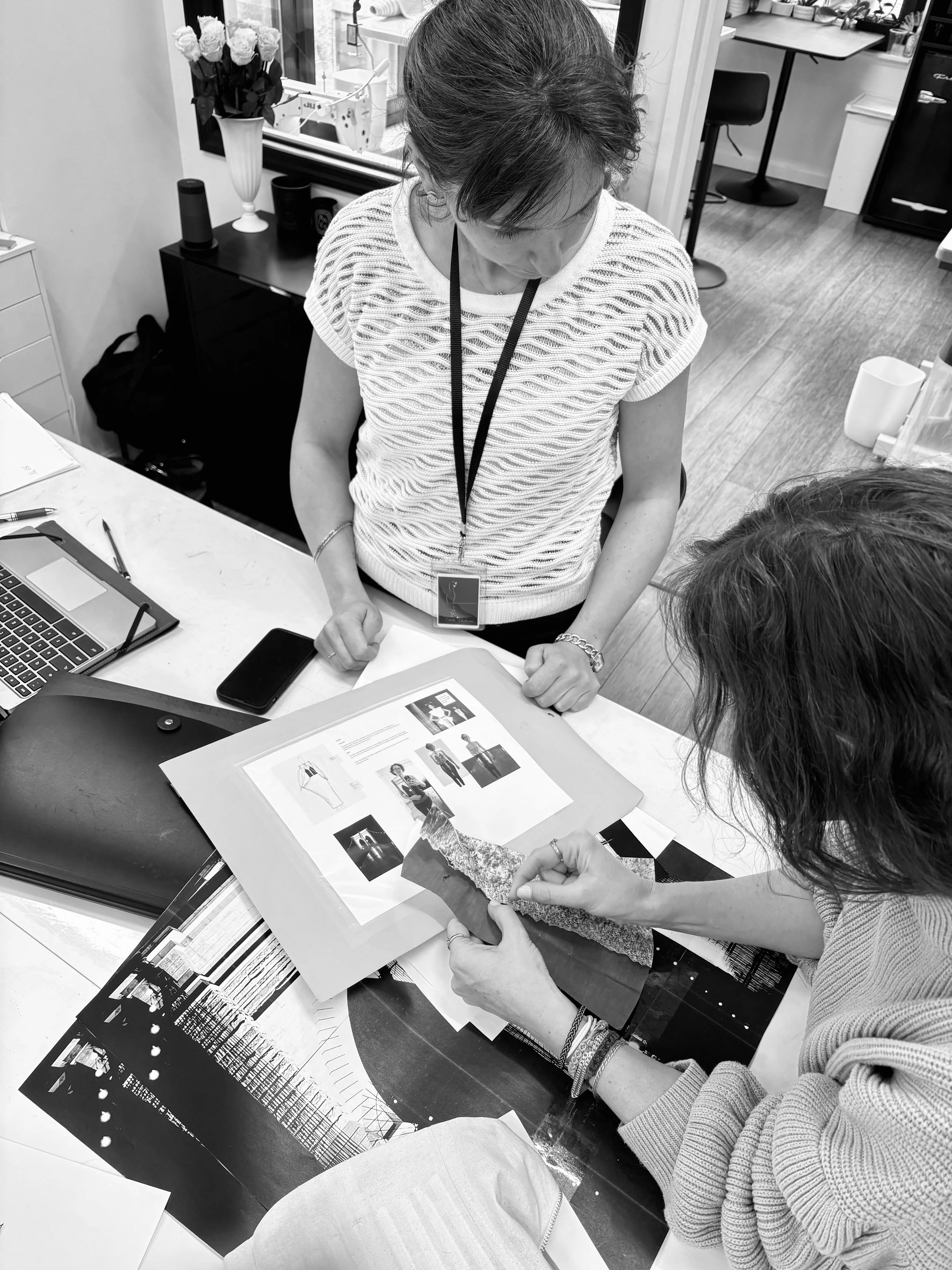 Estelle Chatorrier and Sarah Esmoingt reviewing a doll-sized paper prototype of the Memoria dress during development