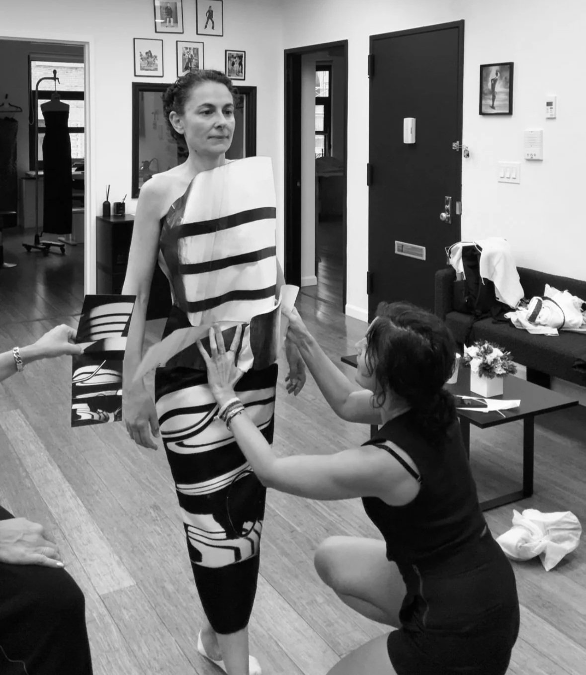 Nicky Conti and textile artist Sarah Esmoingt examining the alignment of the printed top and skirt during a fitting