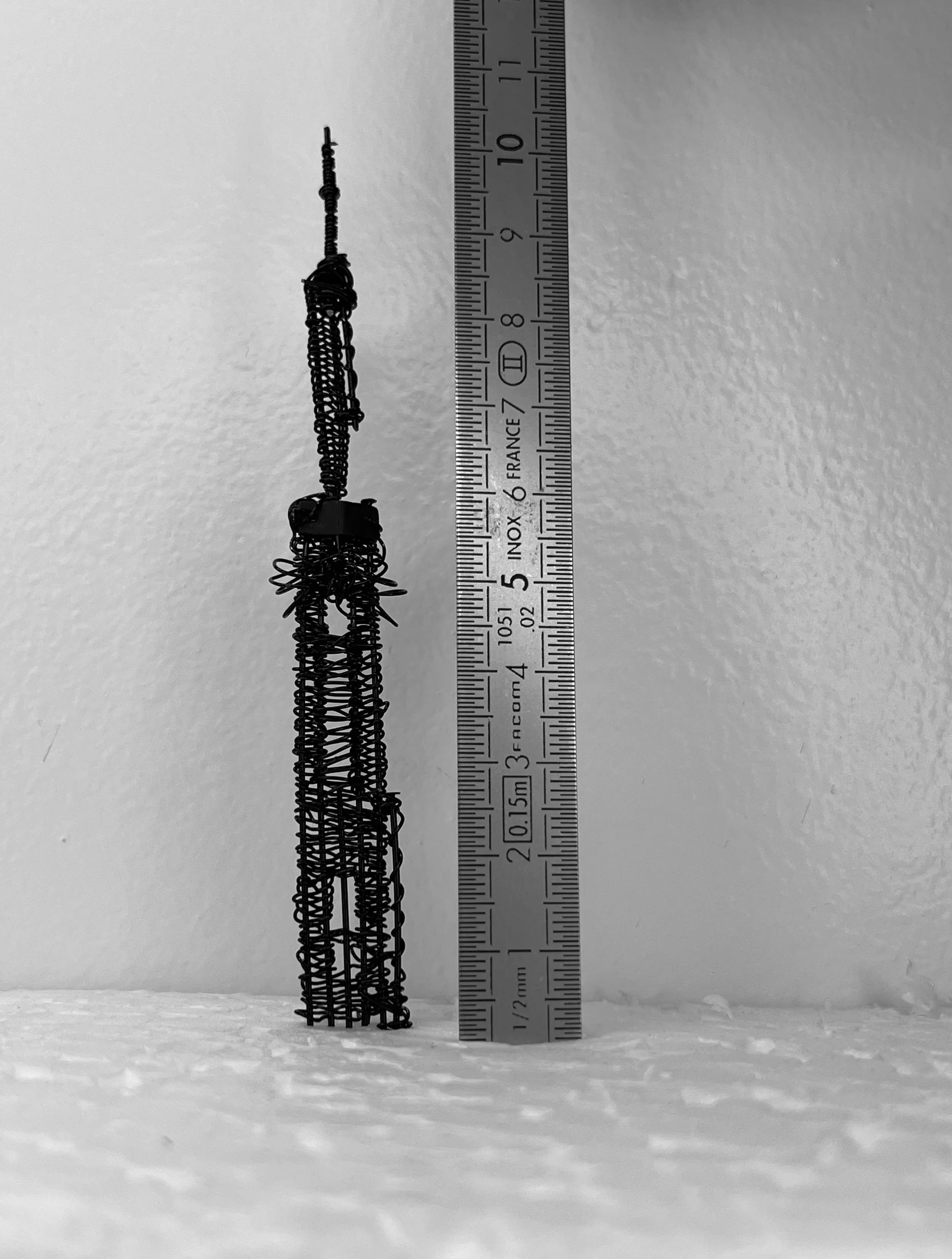 Handmade spire detail for the Empeiria garment placed next to a ruler to show scale