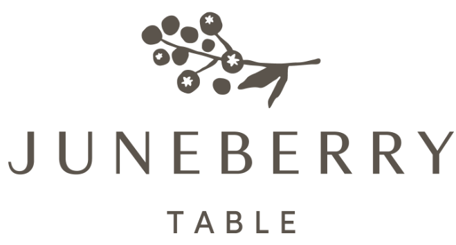 Logo for JUNEBERRY TABLE featuring a stylized branch with berries above the text.