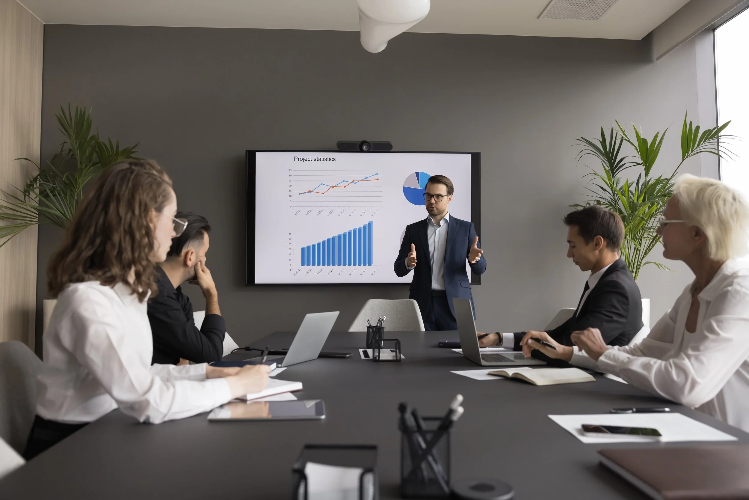 Revenue operations strategist presenting performance data during a B2B strategy meeting with Driscoll Media Group