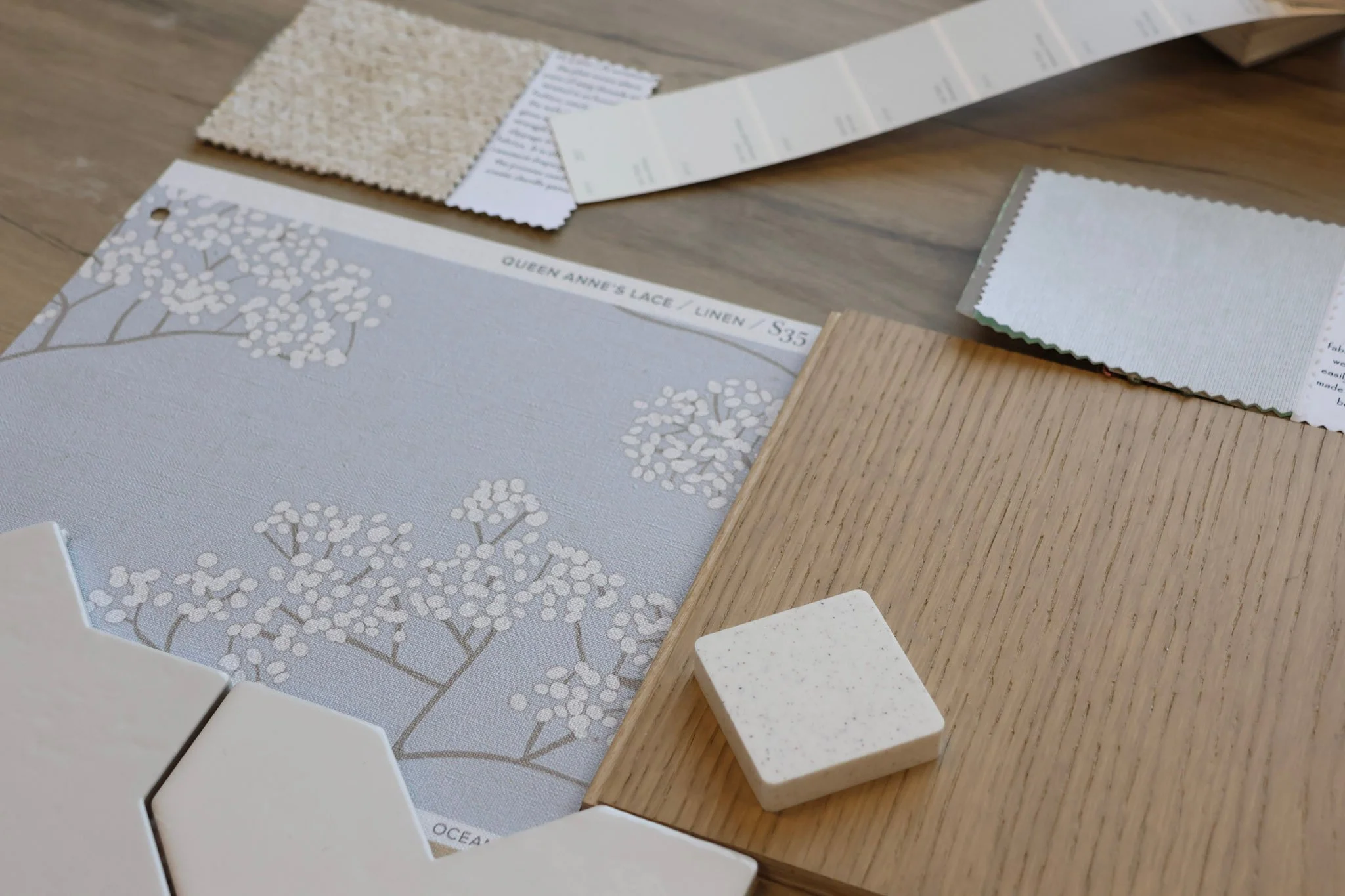 Scandinavian Organic interior design flatlay, includes tile options, paint swatches, wallpaper, wood flooring, and countertop samples.