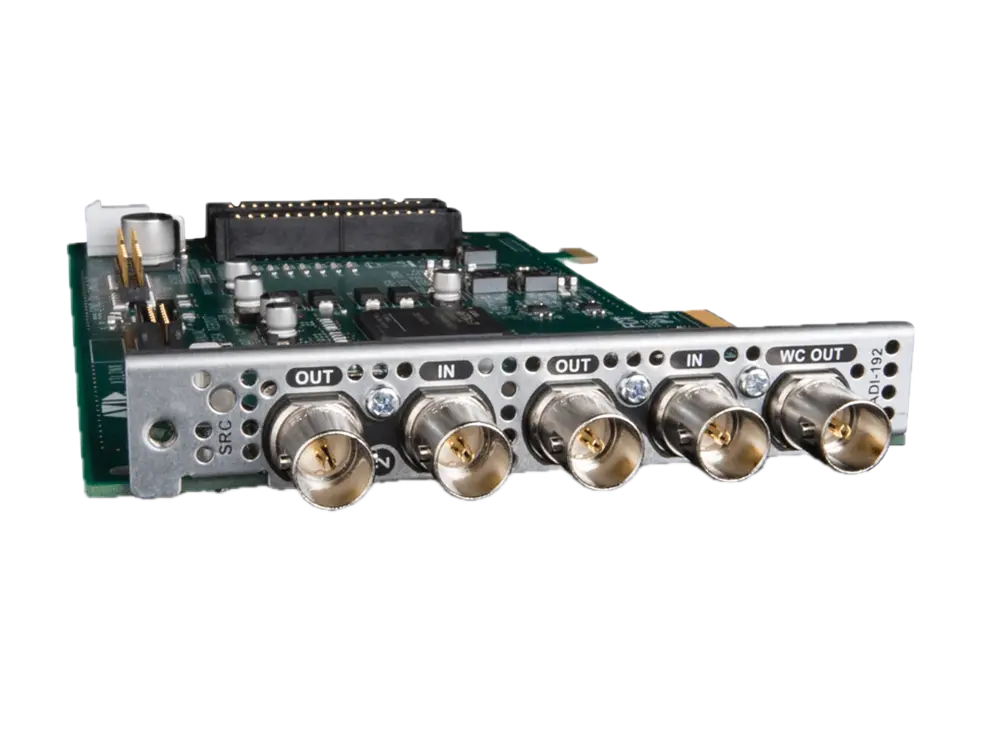 A circuit board with multiple BNC connectors labeled OUT and IN for communications or video signals.