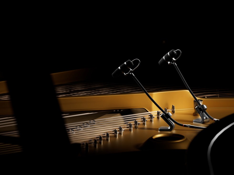 Close-up of the hammers inside a grand piano with microphones positioned above.