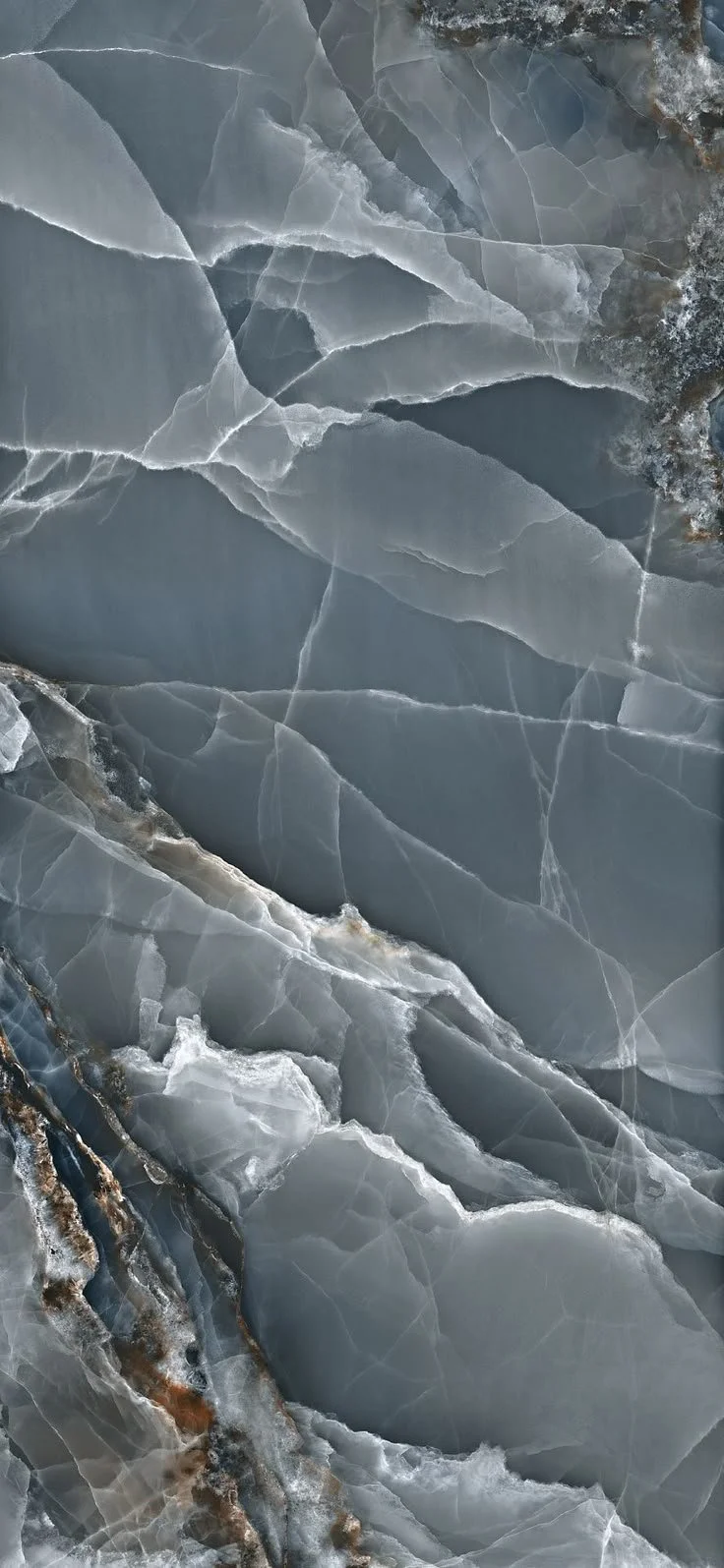 Close-up of a textured grey and white marble surface with intricate veining.