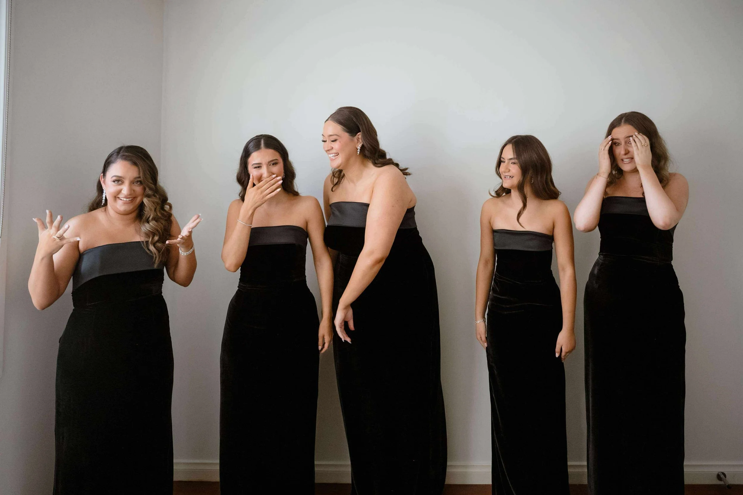 Five women in bespoke black strapless evening gowns after custom tailoring in ringwood.