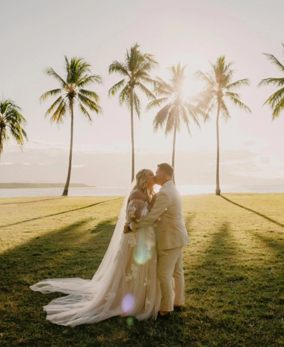 Bride and groom kissing at sunset after professional bridal alterations and wedding dress tailoring