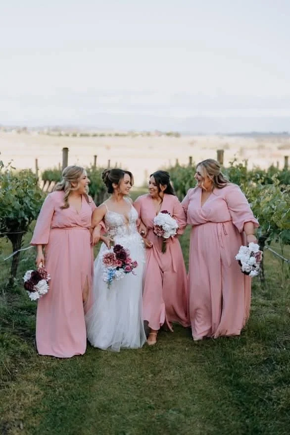 Bride in a lace white wedding gown holding a bouquet of white roses, standing in a bright room after professional bridal alterations in Ringwood, Melbourne.